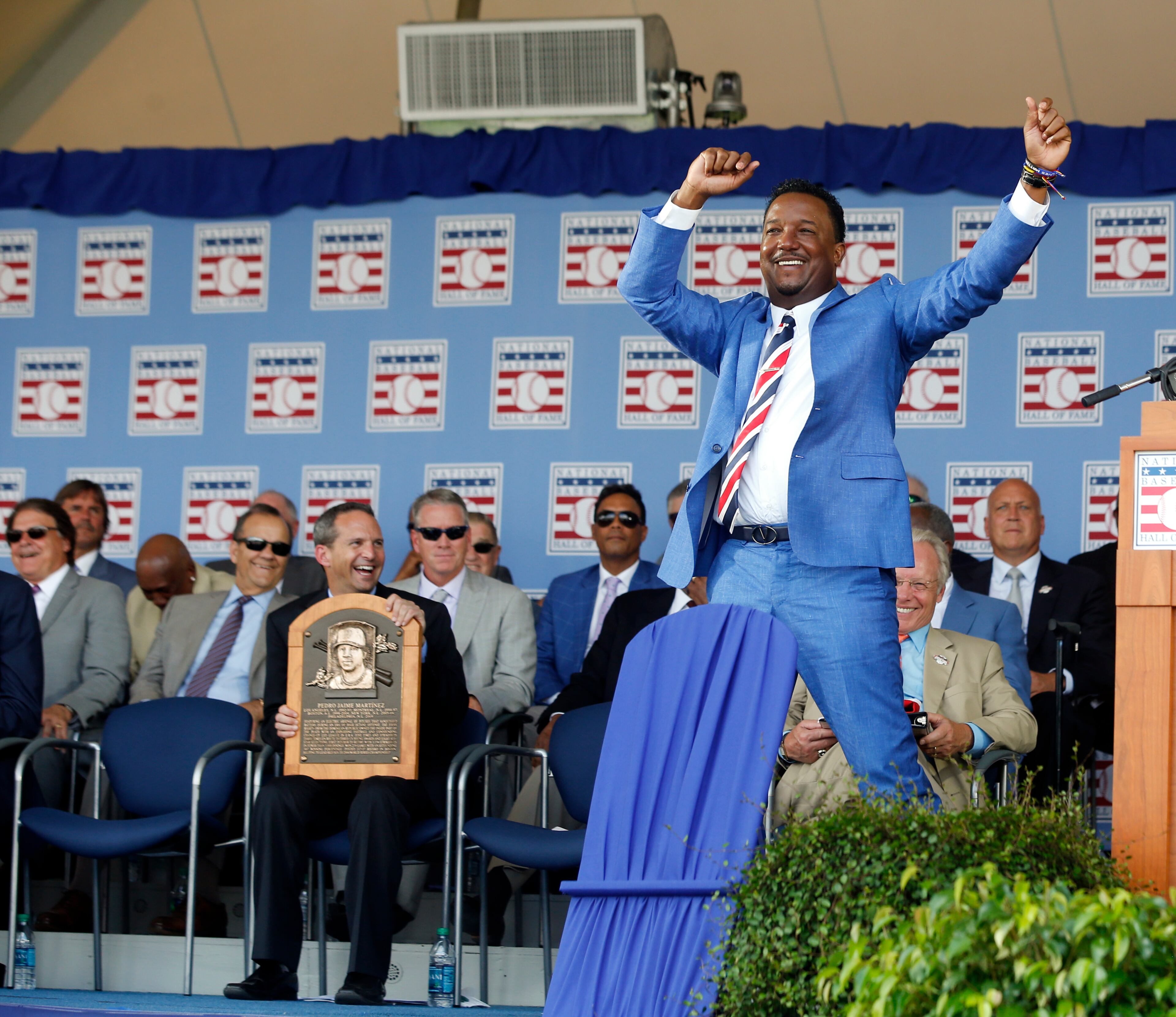 National Baseball Hall of Fame inductee Pedro Martinez dances as he is introduced during an induction ceremony at the Clark Sports Center on Sunday, July 26, 2015, in Cooperstown, N.Y. (AP Photo/Mike Groll)