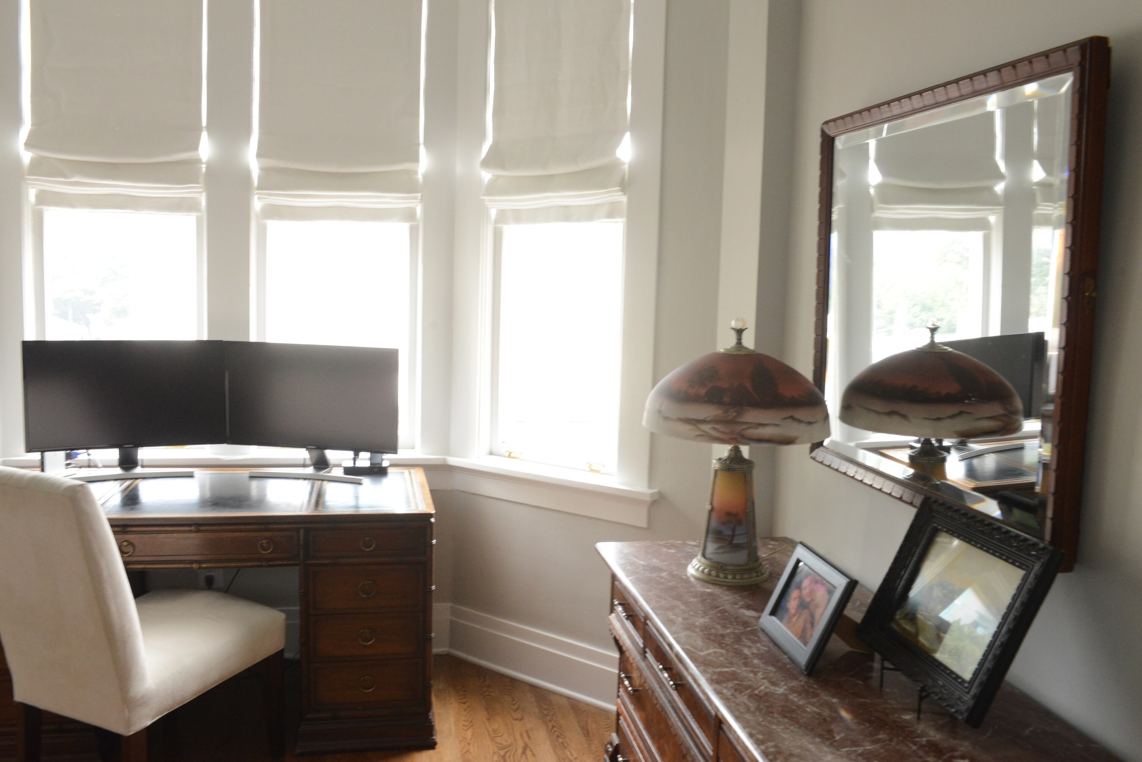 Lohoff, a director of compliance, uses the office area in his guest bedroom to work from home when needed. He decorated the multi-functional space in a transitional style, incorporating a modern white chair with a wooden executive desk and a walnut and maple dresser and mirror. Both are family antiques.
