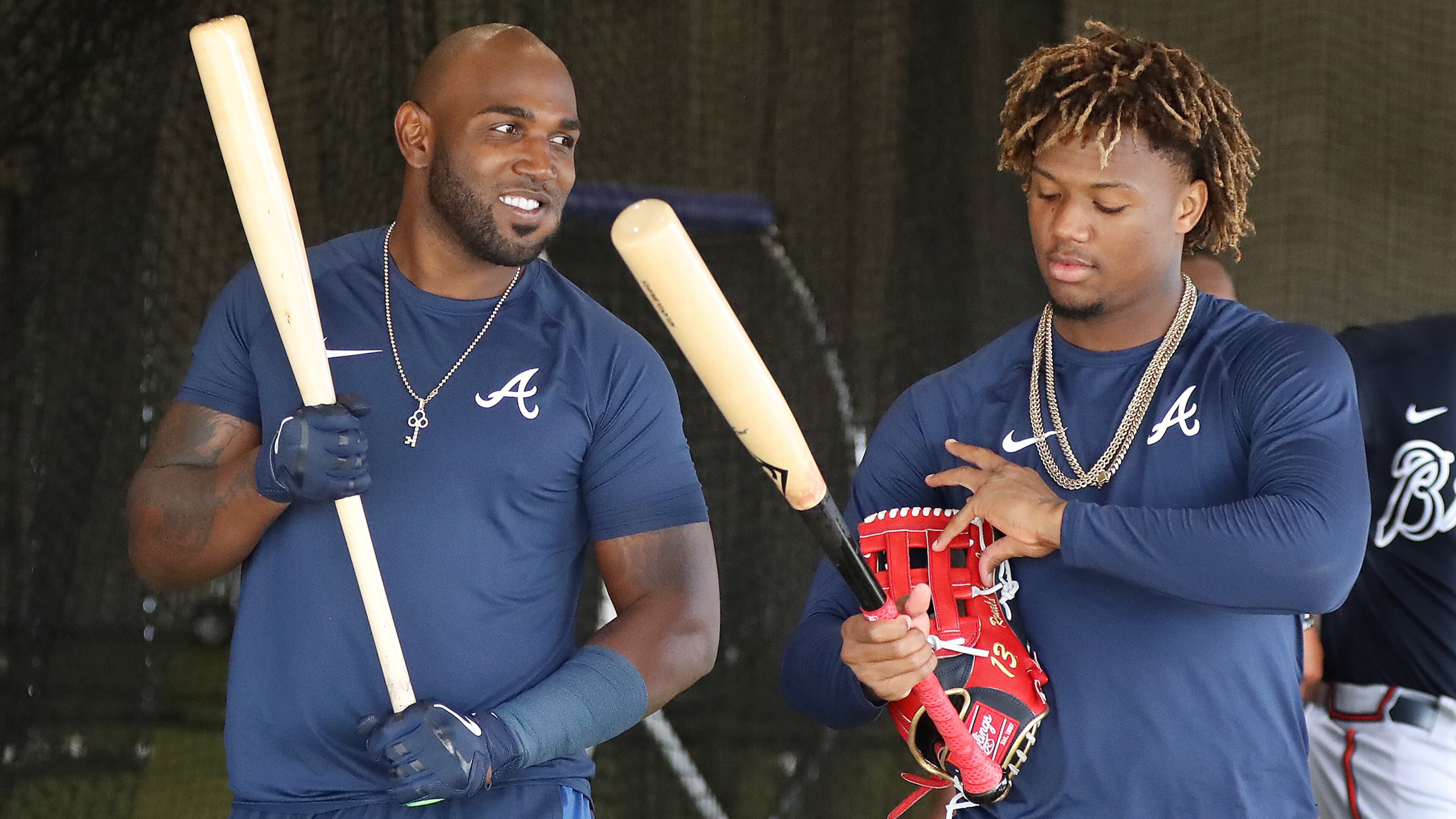 Braves outfielders Marcell Ozuna (left) and Ronald Acuna (right) talk in the batting cages at spring training last month.