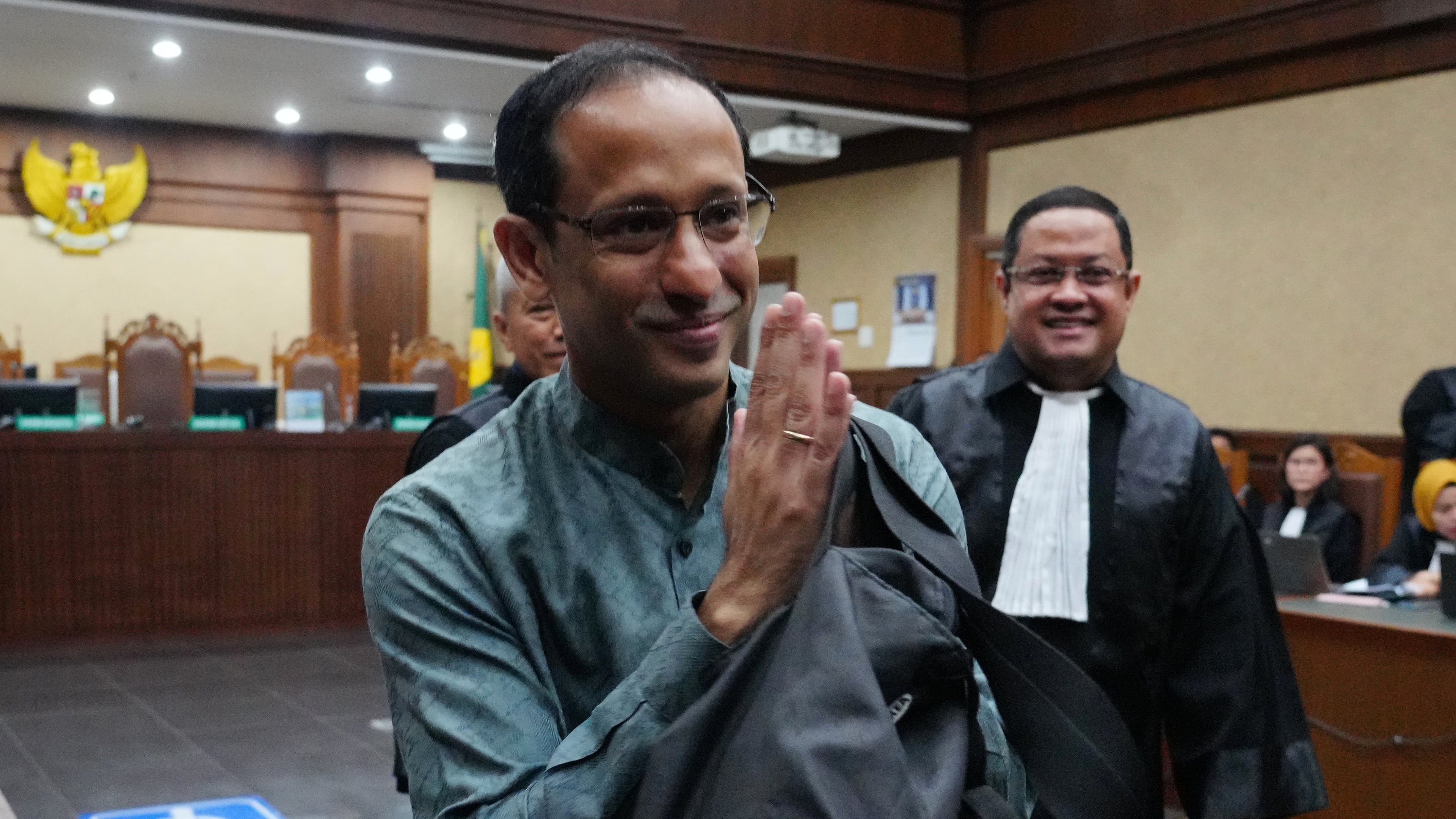 Nadiem Anwar Makarim, the co-founder of Indonesia's payments platform and ride hailing company Gojek and former education minister, reacts as he enters the courtroom for his first trial hearing at the Corruption Court in Jakarta, Indonesia, Monday, Jan. 5, 2026. (AP Photo/Tatan Syuflana)