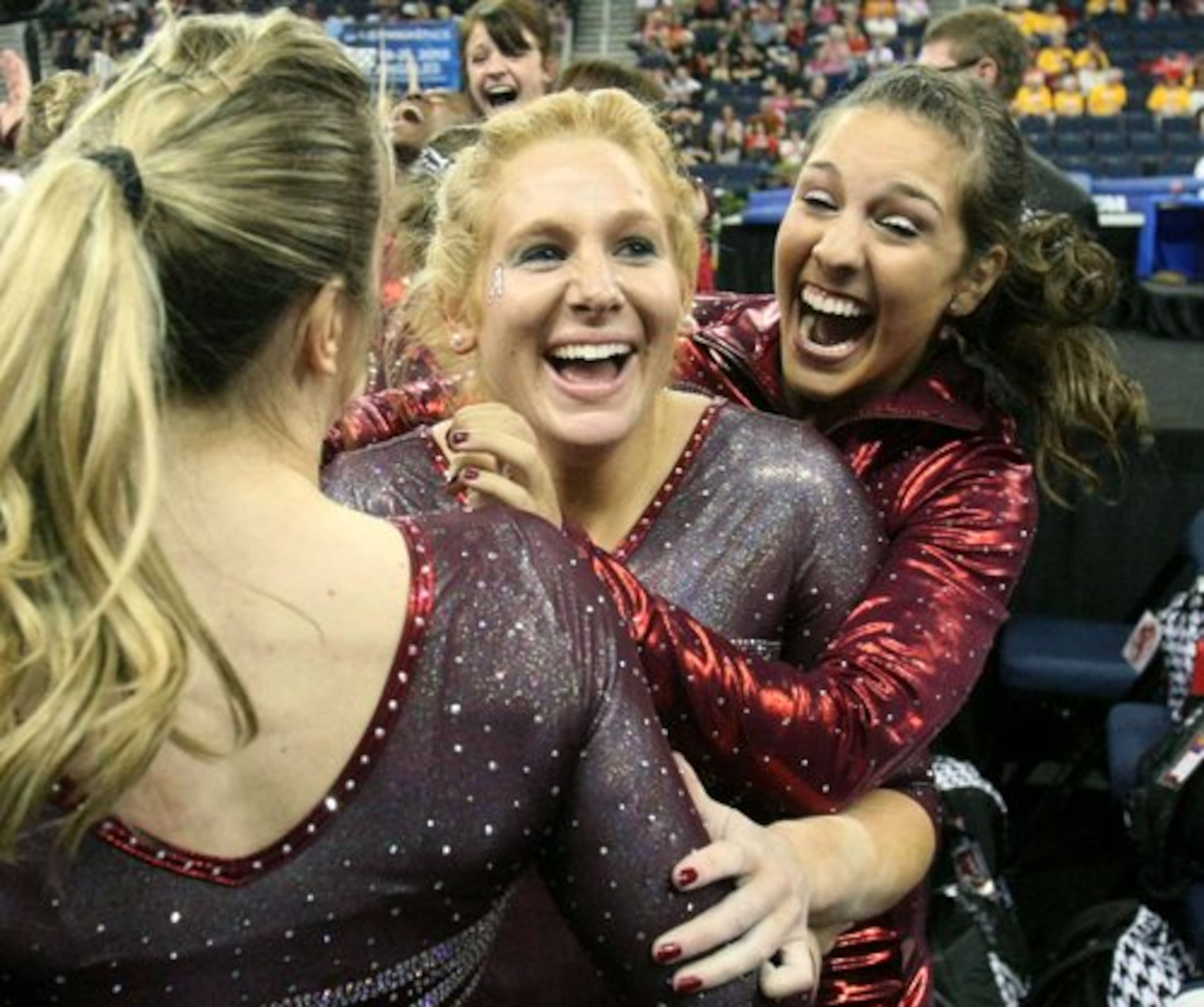 Alabama gymnasts from left to right; Geralen Stack-Eaton, Ashley Priess, and Marissa Gutierrez celebrate their win.