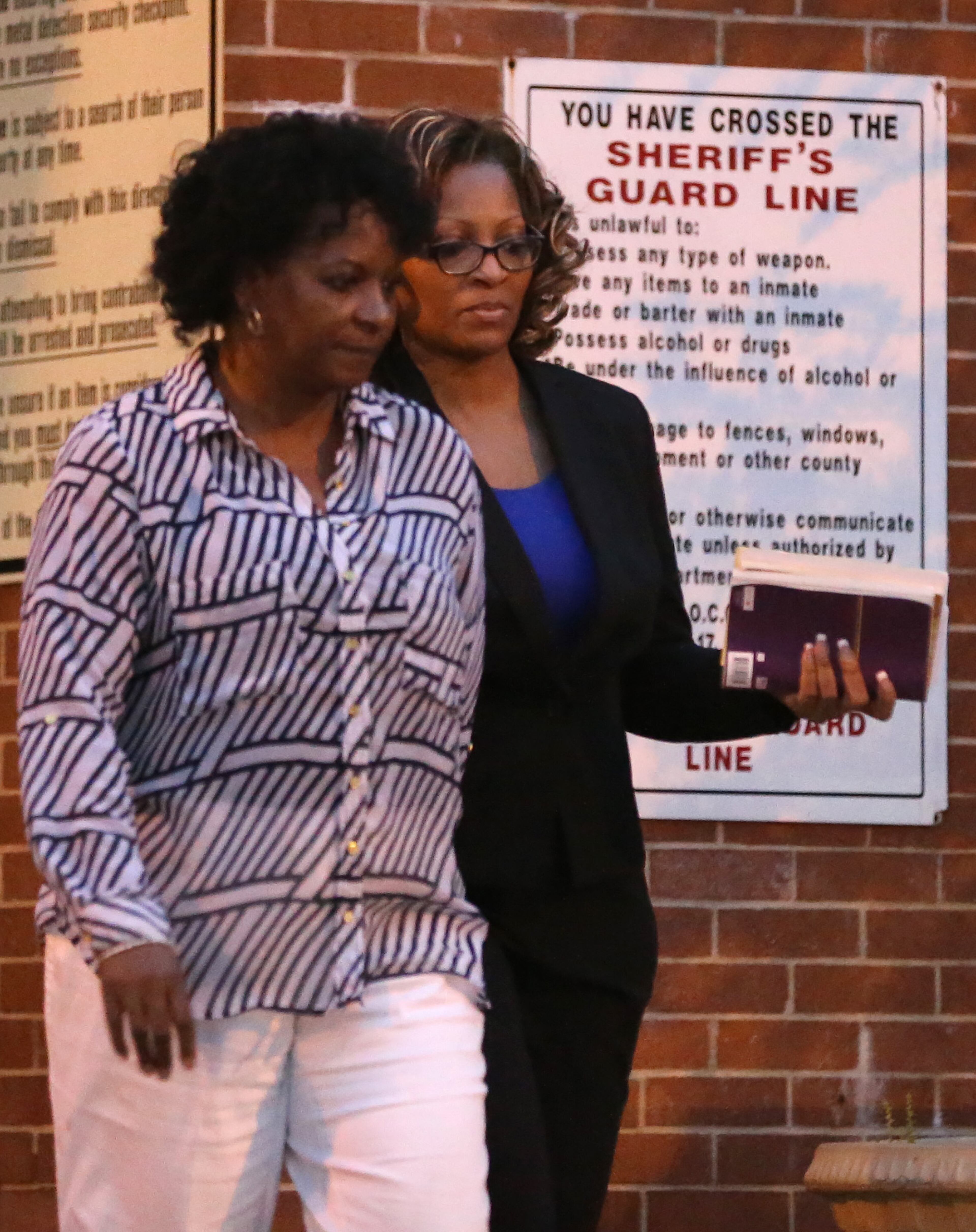 Former Atlanta Public Schools teacher Angela Williamson, right, leaves the Fulton County Jail on Tuesday night April 14, 2015. Ben Gray / bgray@ajc.com