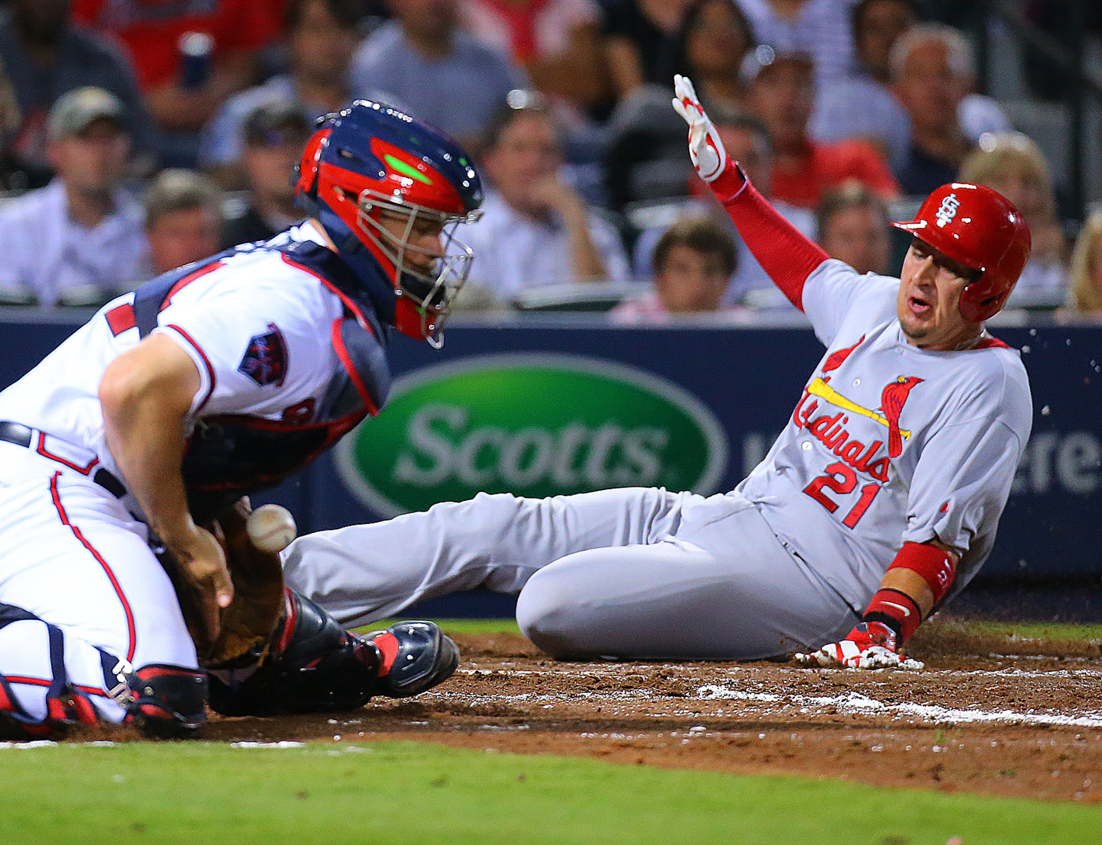 Cardinals Allen Craig scores past Braves catcher Evan Gattis, the throw arriving late on a RBI single by Peter Bourjos for a 4-0 lead over the Braves during the sixth inning of a MLB game on May 5, 2014. CURTIS COMPTON / CCOMPTON@AJC.COM