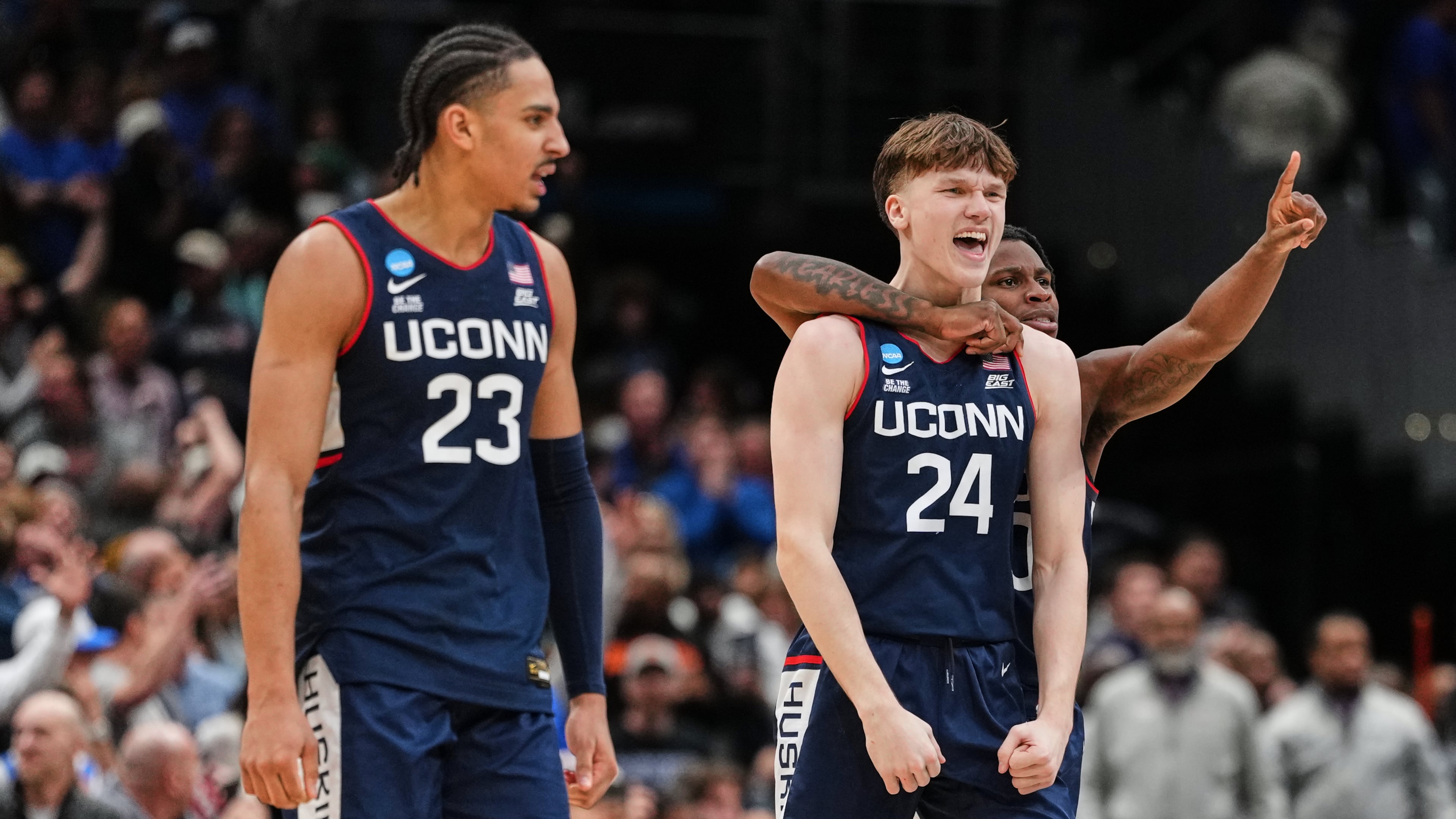 UConn guard Braylon Mullins (24) reacts with teammates after scoring the winning basket against Duke in the Elite Eight of the NCAA college basketball tournament, Sunday, March 29, 2026, in Washington. (AP Photo/Abbie Parr)