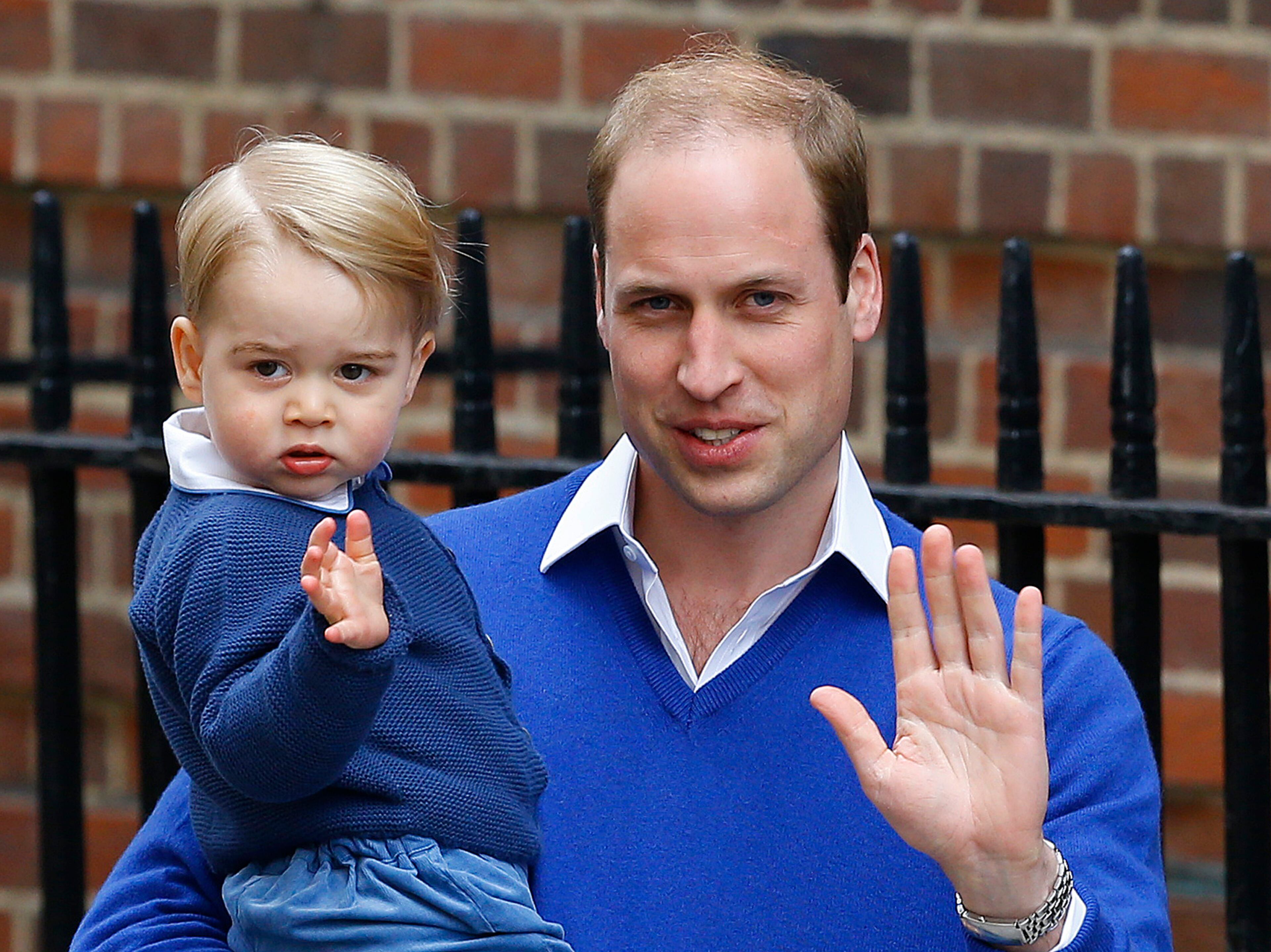 Britain's Prince William and his son, Prince George, wave as they return to St. Mary's Hospital's exclusive Lindo Wing, London, on May 2, 2015. William's wife, Kate, the Duchess of Cambridge, gave birth to a baby girl.