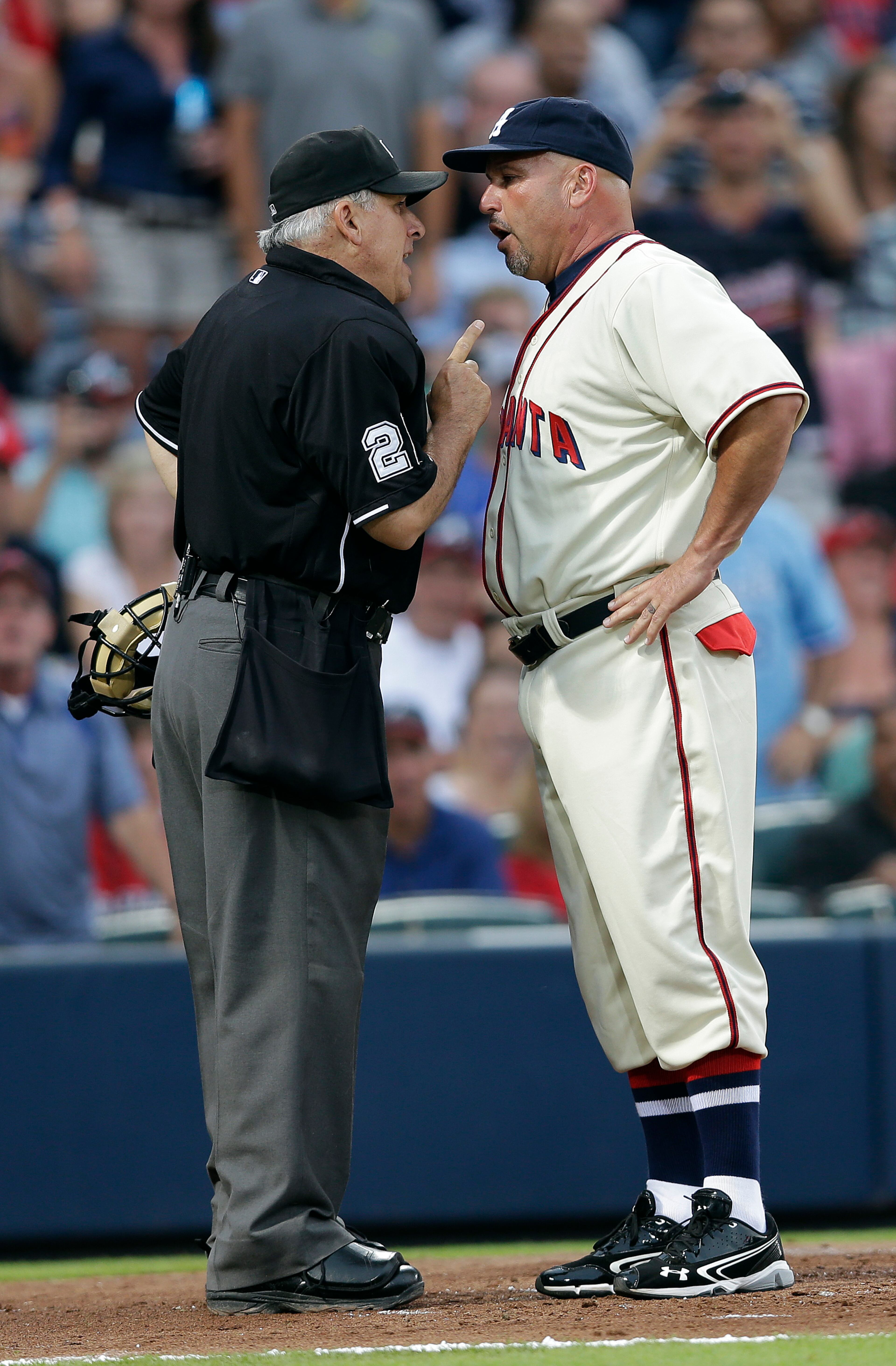 Atlanta Braves manager Fredi Gonzalez (33) argues with home plate umpire Larry Vanover after being ejected in the fourth inning of a baseball game against the Washington Nationals in Atlanta, Saturday, June 1, 2013. (AP Photo/John Bazemore)