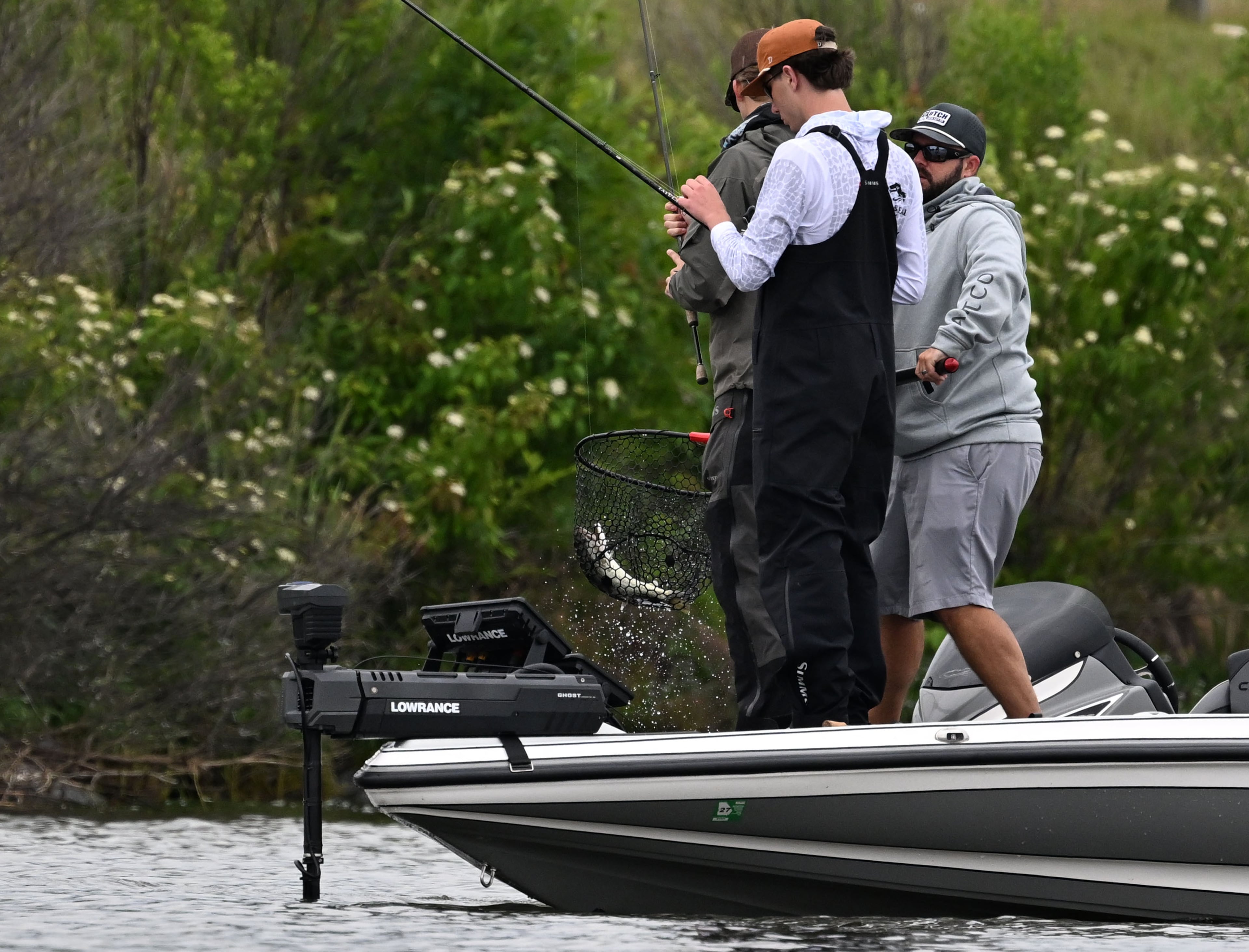 Prince Avenue's Luke Milner and John Casto reel one in at the GHSA State Bass Fishing Championship. (Hyosub Shin/AJC)