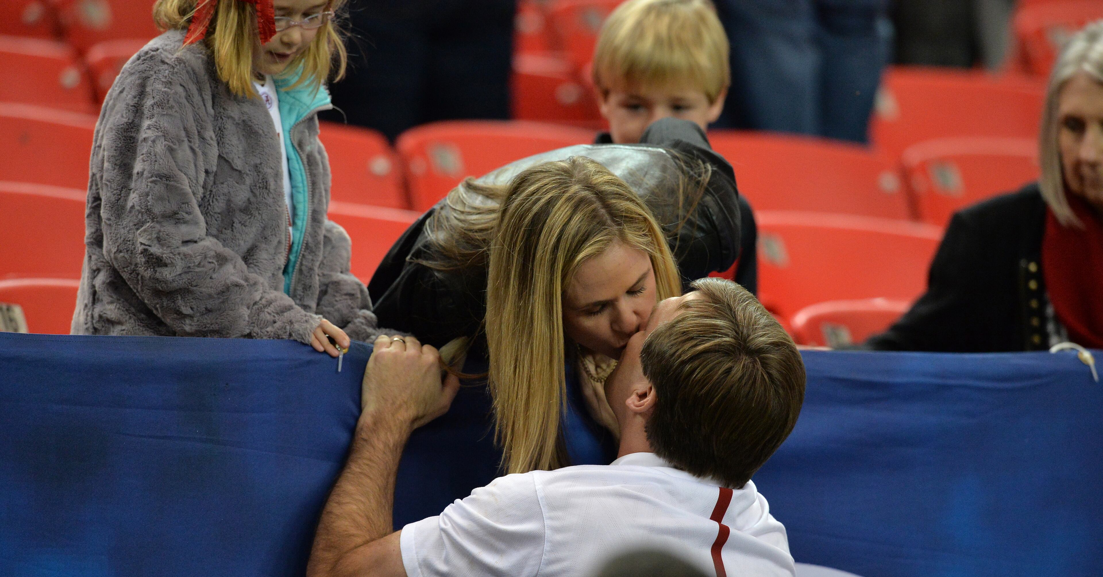 Alabama Crimson Tide defensive coordinator and soon to be Georgia coach, Kirby Smart gets a kiss from his wife, Mary Beth, before the teams took the field to arm-up for the the SEC Championship at the Georgia Dome Saturday December 5, 2015. BRANT SANDERLIN/BSANDERLIN@AJC.COM