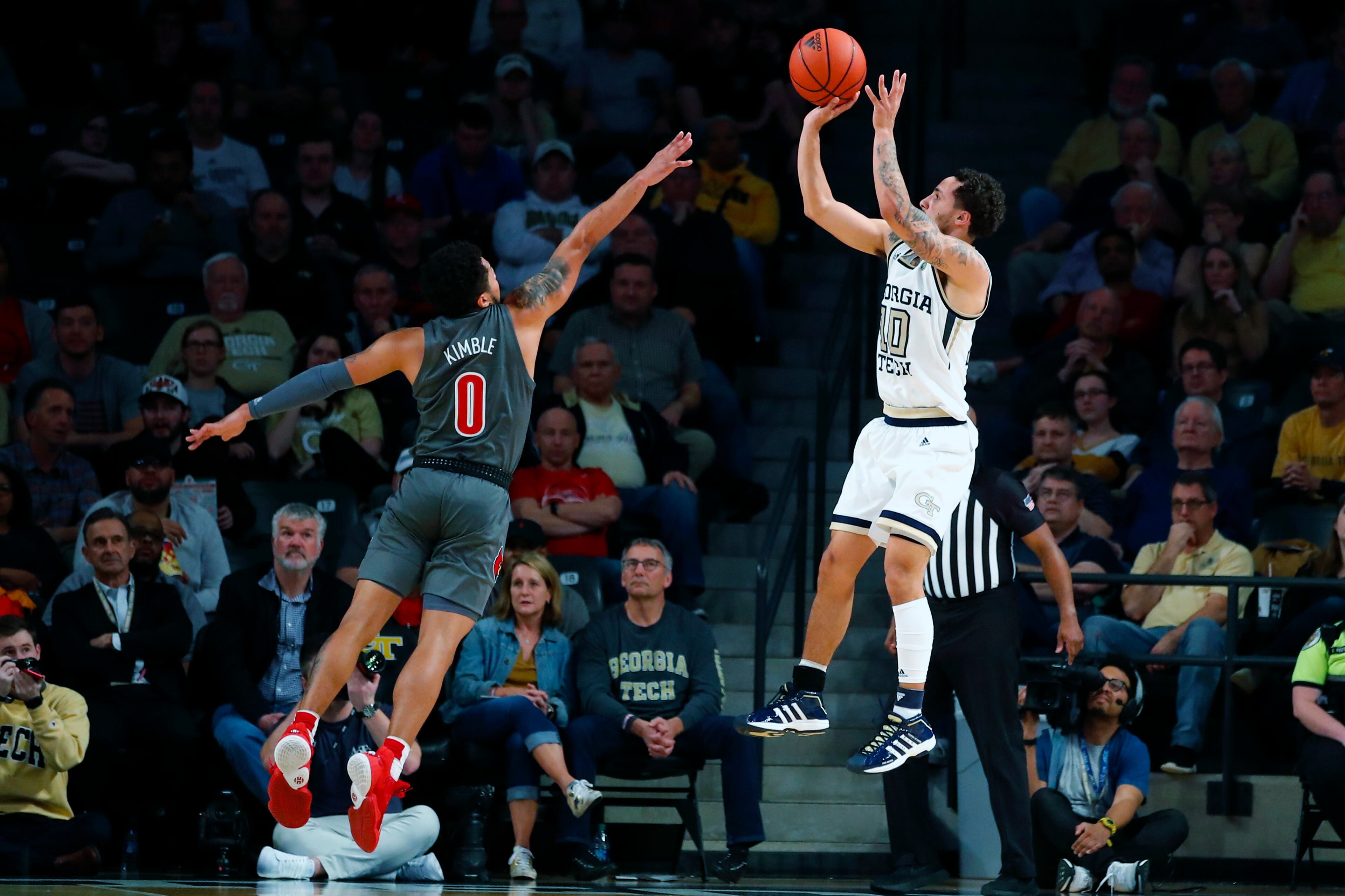 Georgia Tech guard Jose Alvarado (10) shoots as Louisville guard Lamarr Kimble (0) defends during the second half of an NCAA college basketball game in Atlanta, Wednesday, Feb. 12, 2020. (AP Photo/Todd Kirkland)