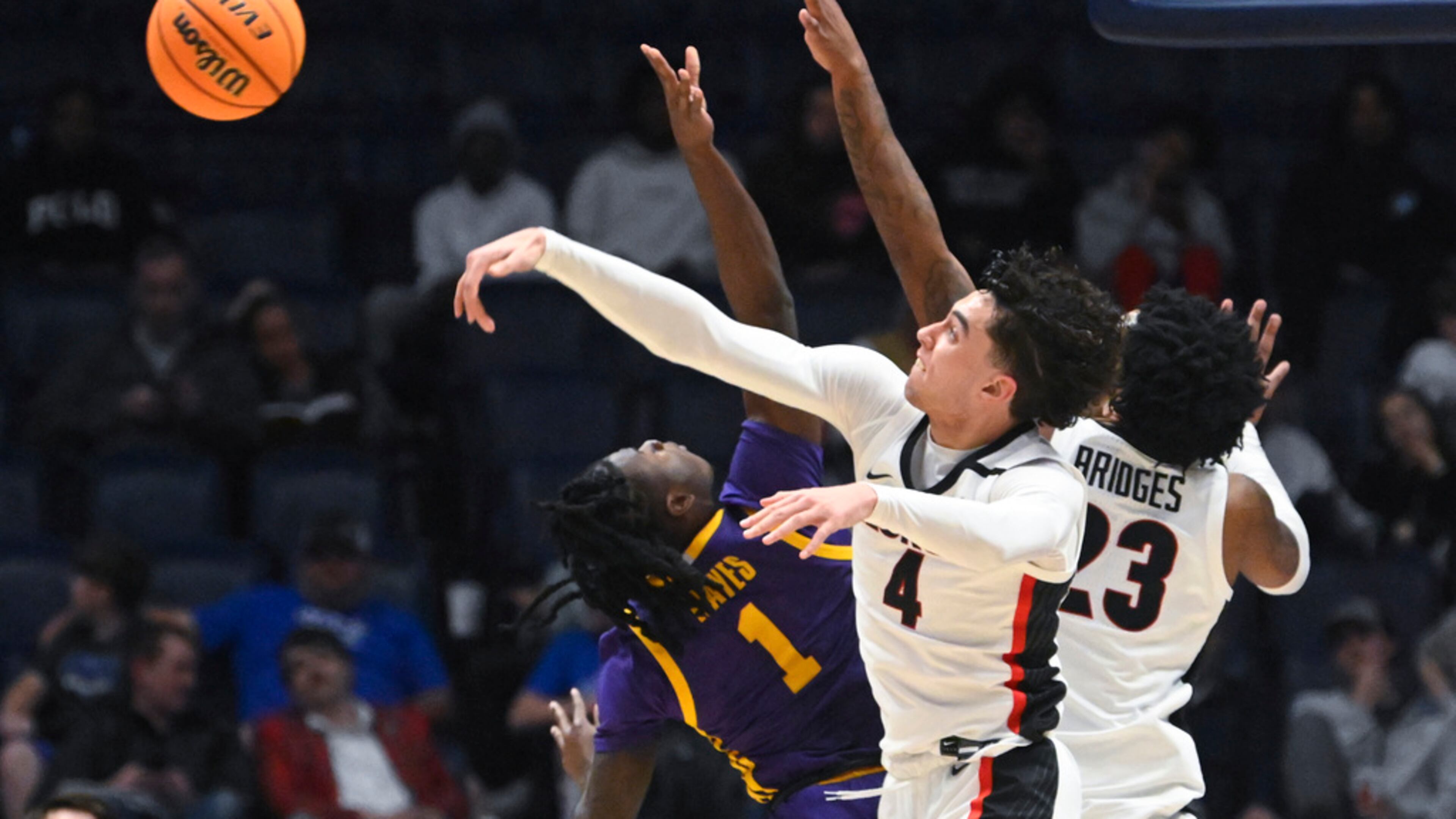 Georgia guard Jusaun Holt (4) rejects a shot by LSU guard Cam Hayes (1) as Braelen Bridges also defends in the first round of the SEC Tournament, Wednesday, March 8, 2023, in Nashville, Tenn. LSU won 72-67. (AP Photo/John Amis)
