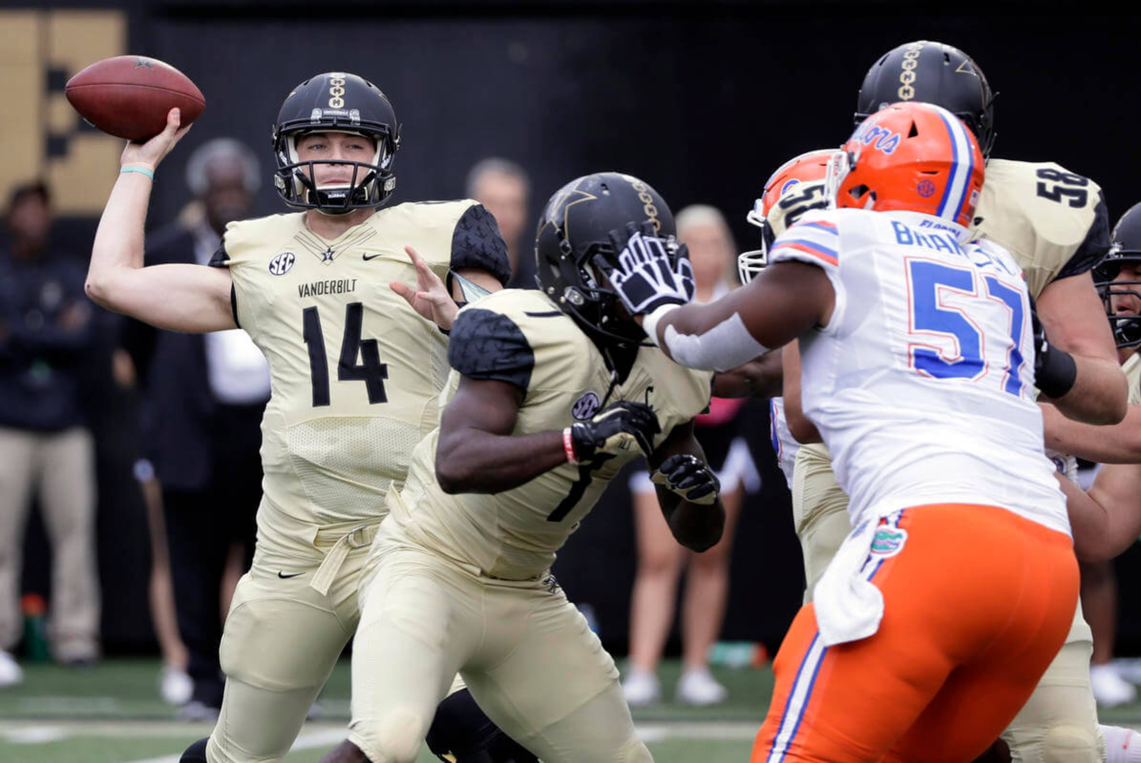 Vanderbilt quarterback Kyle Shurmur (14) passes as he is pressured by Florida defensive lineman Caleb Brantley (57) in the first half of an NCAA college football game Saturday, Oct. 1, 2016, in Nashville, Tenn. (AP Photo/Mark Humphrey)