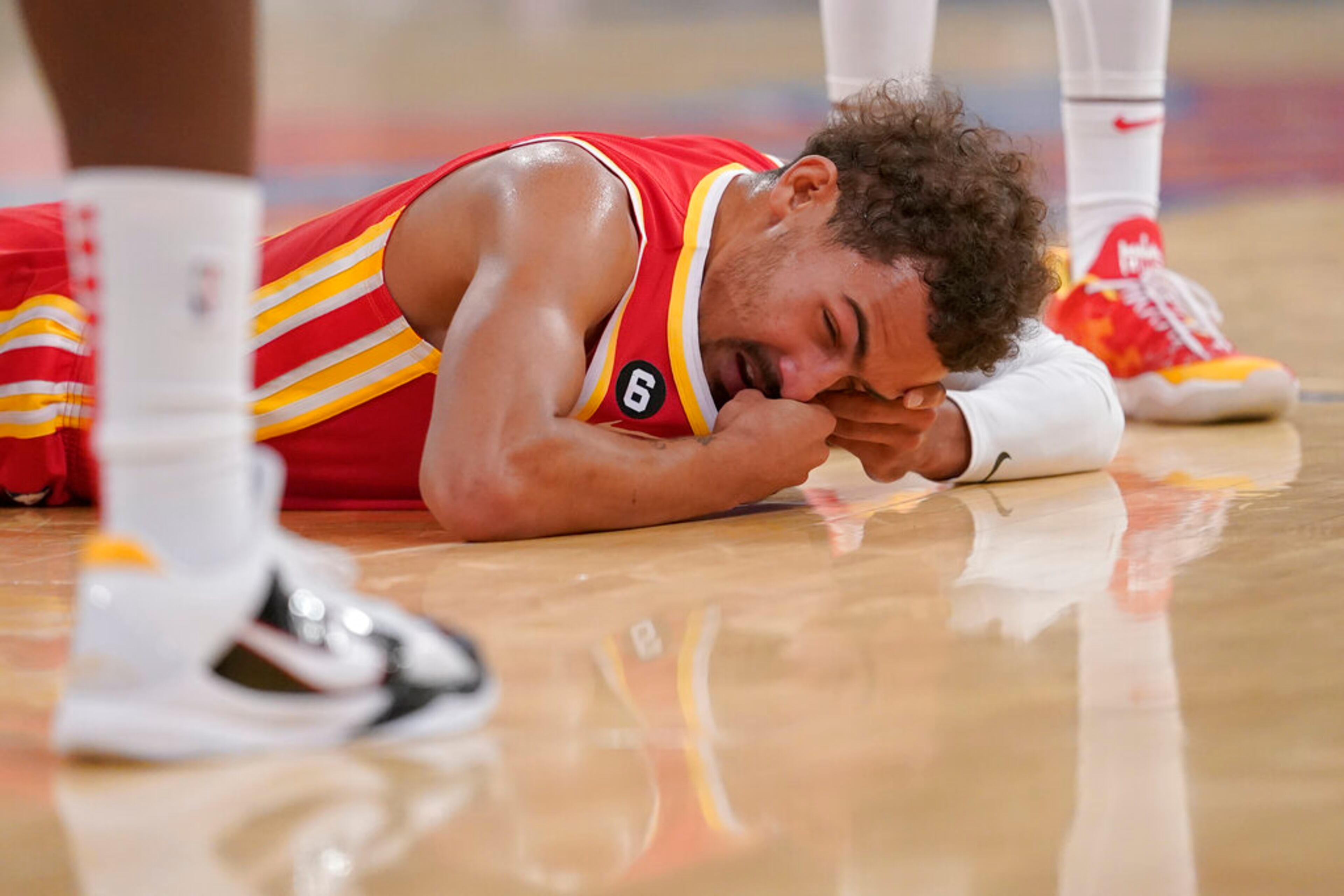 Atlanta Hawks guard Trae Young lies on the court after being injured during the second half of the team's NBA basketball game against the New York Knicks, Wednesday, Nov. 2, 2022, at Madison Square Garden in New York. The Hawks won 112-99. (AP Photo/Mary Altaffer)