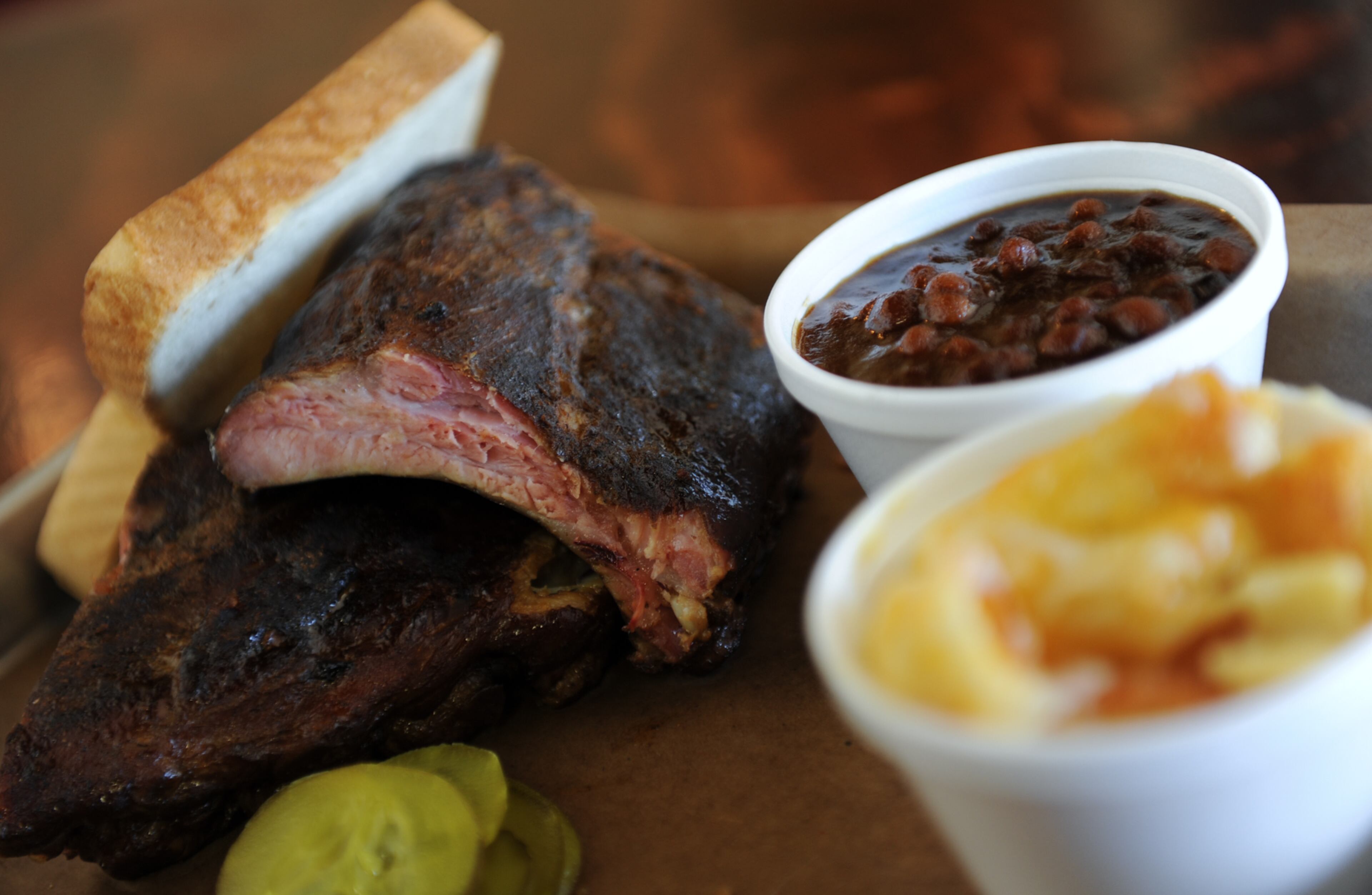 Pork baby back ribs plate, a slice of Texas toast, mac and cheese and baked beans from Grand Champion BBQ.
