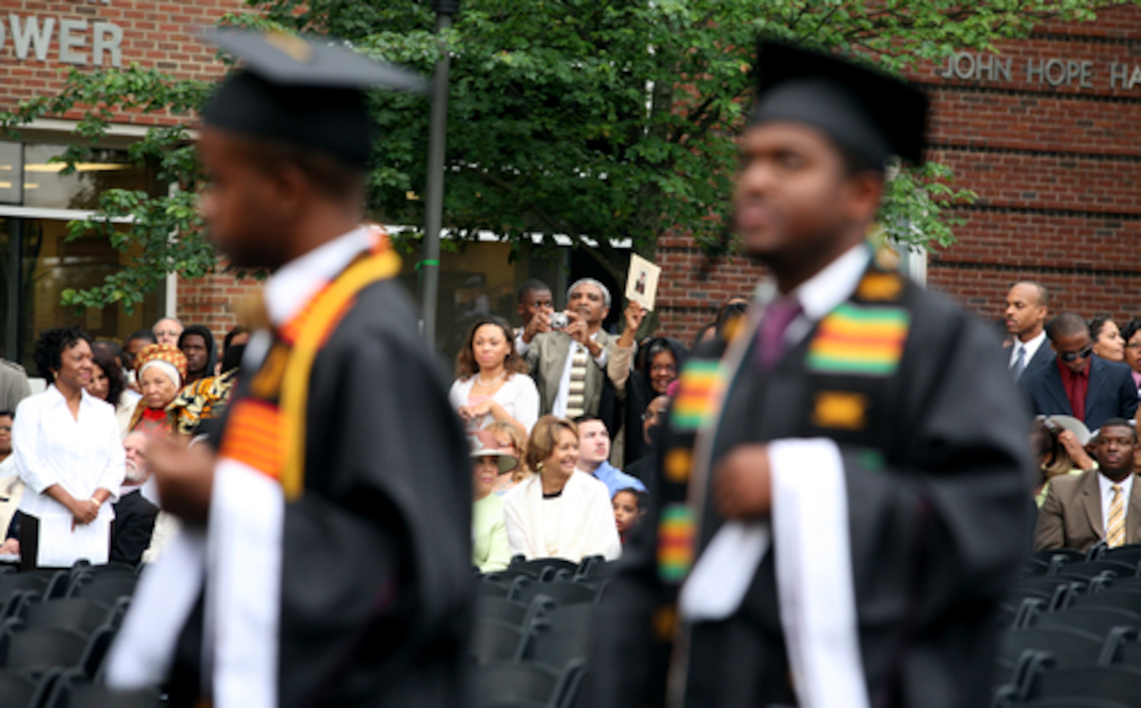 Family and friends watch as some 500 graduates enter the Century Campus.