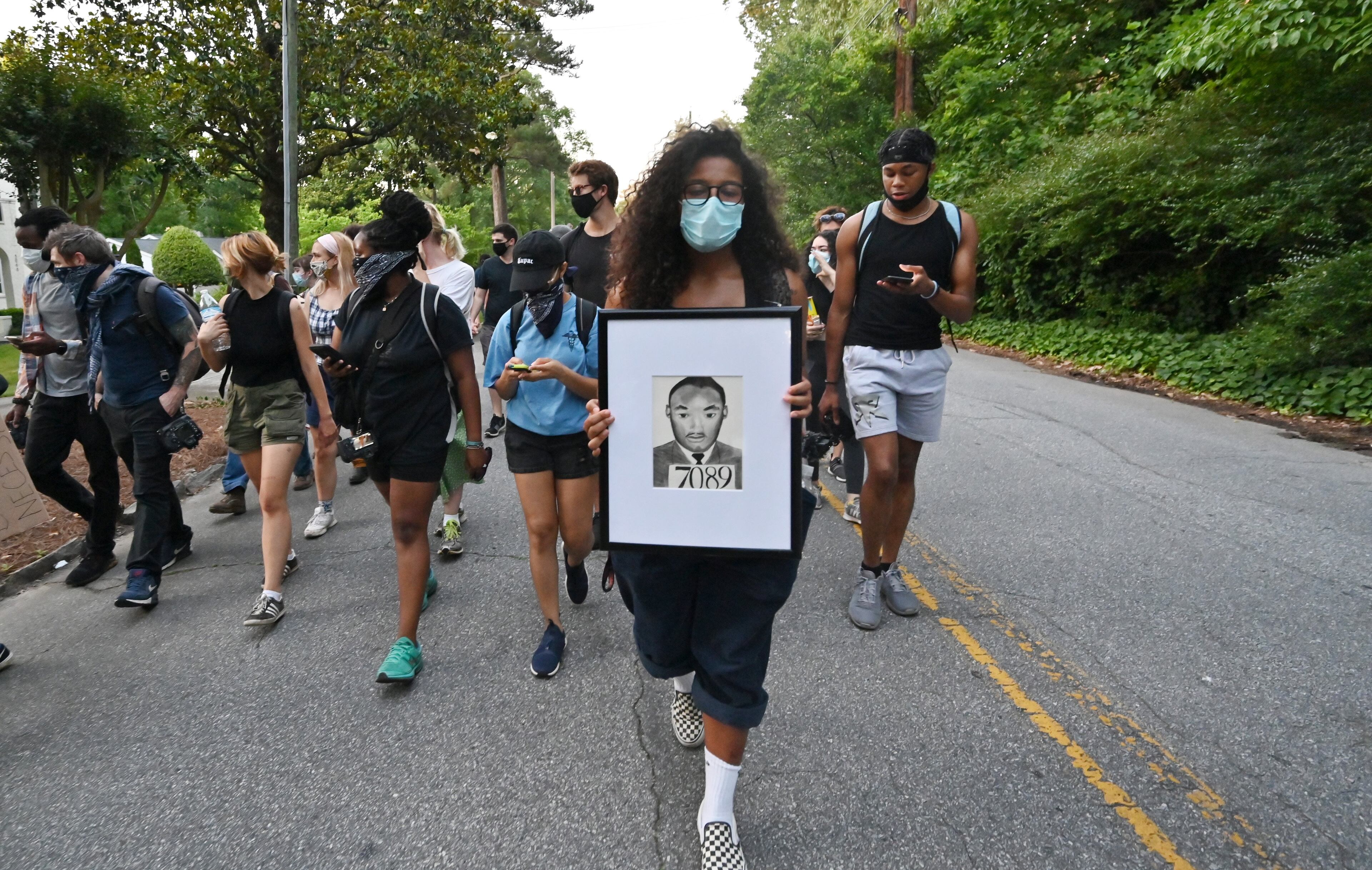 May 30, 2020 Atlanta - Protesters march in Buckhead neighbor after they rallied across the street from the Governor's Mansion in Buckhead on Saturday, May 30, 2020. A second day of protests Saturday began with a crowd outside the Governorâs Mansion and grew to include demonstrations in downtown Atlanta. Mayor Keisha Lance Bottoms implemented a curfew for the city following a night of chaotic protests Friday that led to vandalism and looting in parts of downtown Atlanta and Buckhead. (Hyosub Shin / Hyosub.Shin@ajc.com)