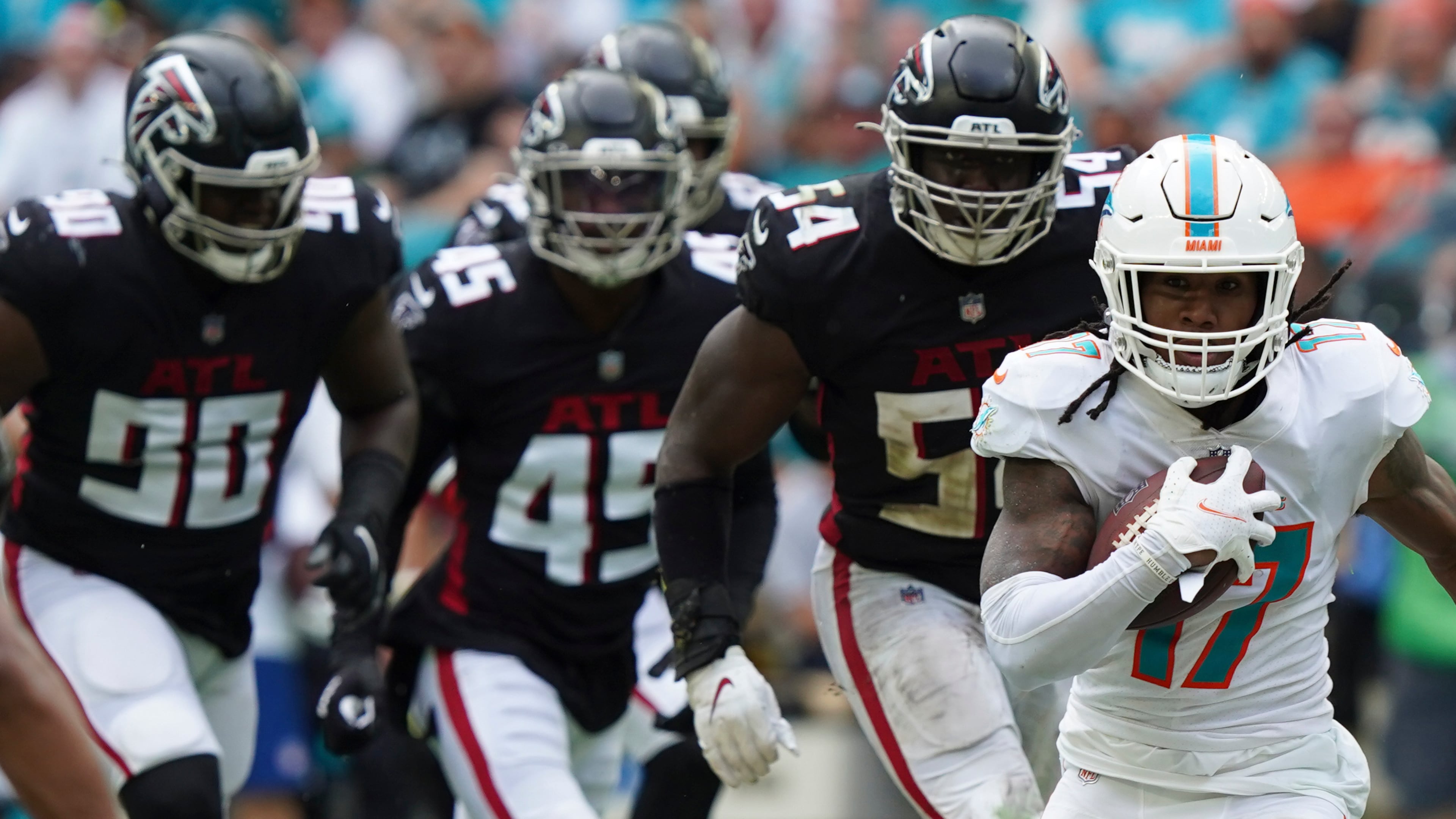 Miami Dolphins wide receiver Jaylen Waddle (17) is pursued by Falcons defensive end Marlon Davidson (90), linebacker Deion Jones (45) and linebacker Foyesade Oluokun (54), during the first half Sunday, Oct. 24, 2021, in Miami Gardens, Fla. (Hans Deryk/AP)