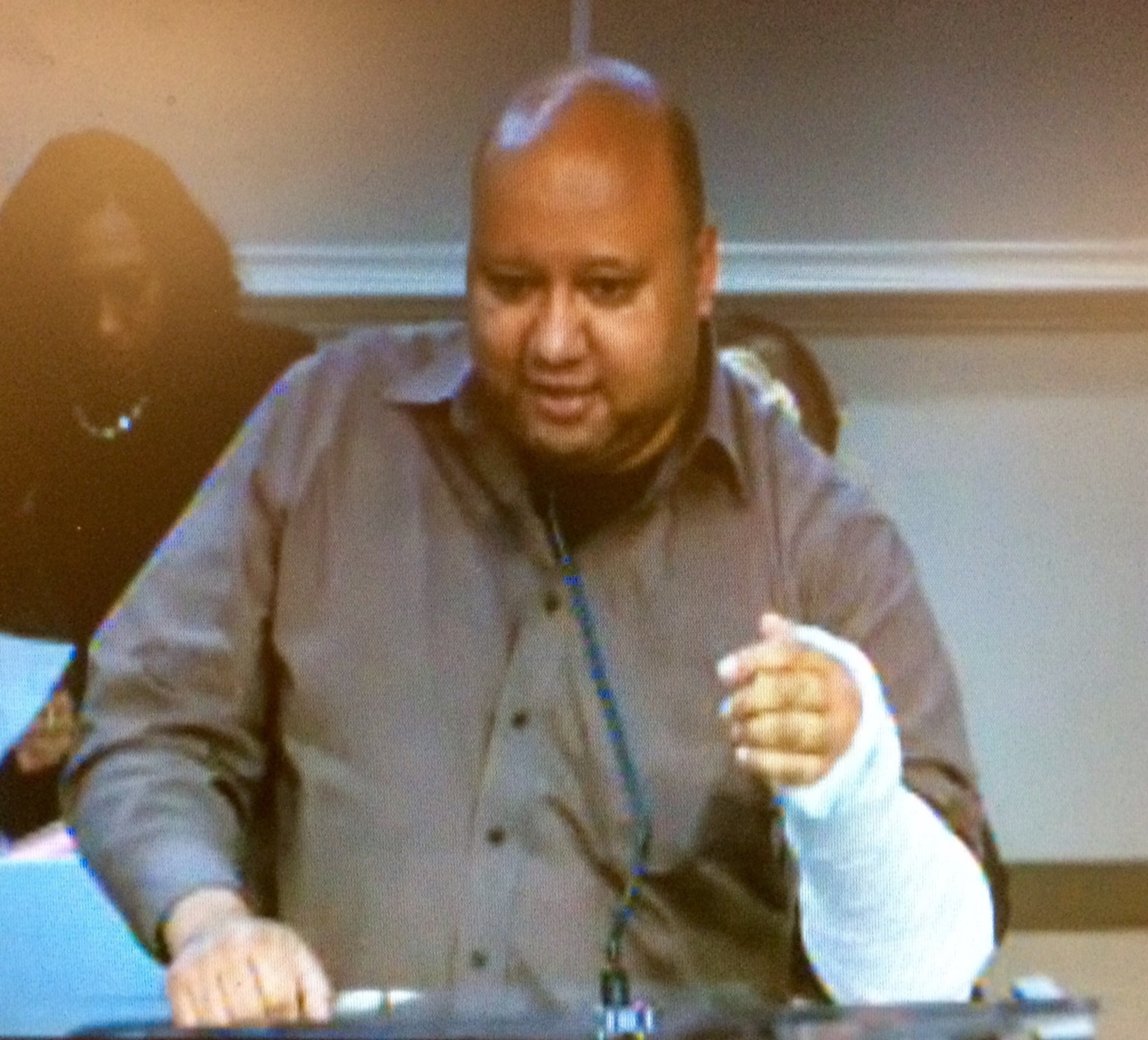 George Chidi, who works in downtown Atlanta, addresses a City Council committee in December 2018 concerning the safety of scooters. “I misjudged a curb and ate pavement,” he told the council, waving his cast.