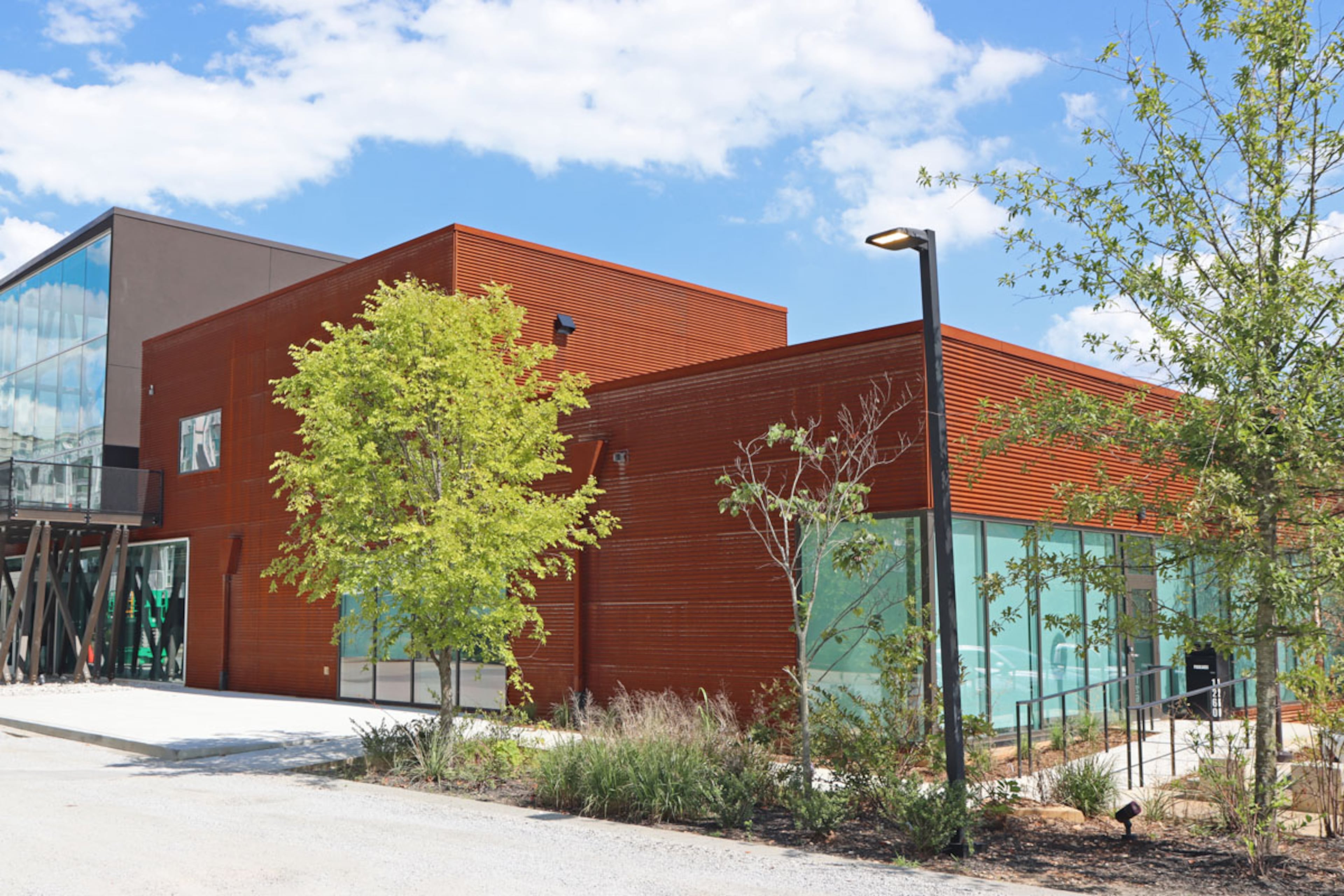 The exterior design of MOCA GA, with its weathered steel beams, old railroad ties, and other industrial details, gives a nod to the area’s railroad roots. (Photo courtesy of MOCA GA)