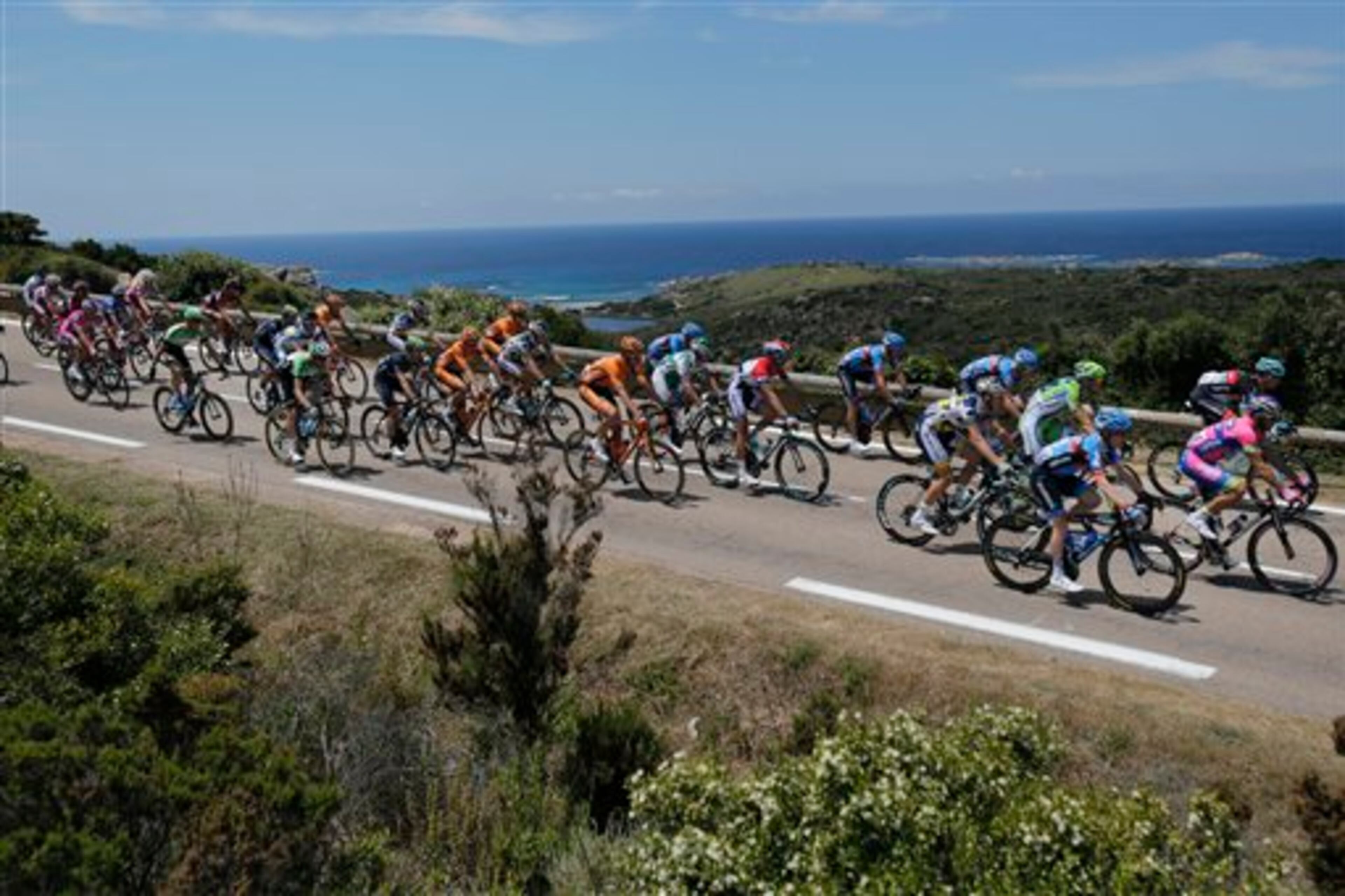 The pack rides along the coast line of the Mediterranean Sea during the first stage of the 100th edition of the Tour de France cycling race over 213 kilometers (133 miles) with start in Porto Vecchio and finish in Bastia, Corsica island, France, Saturday June 29, 2013.(AP Photo/Christophe Ena)
