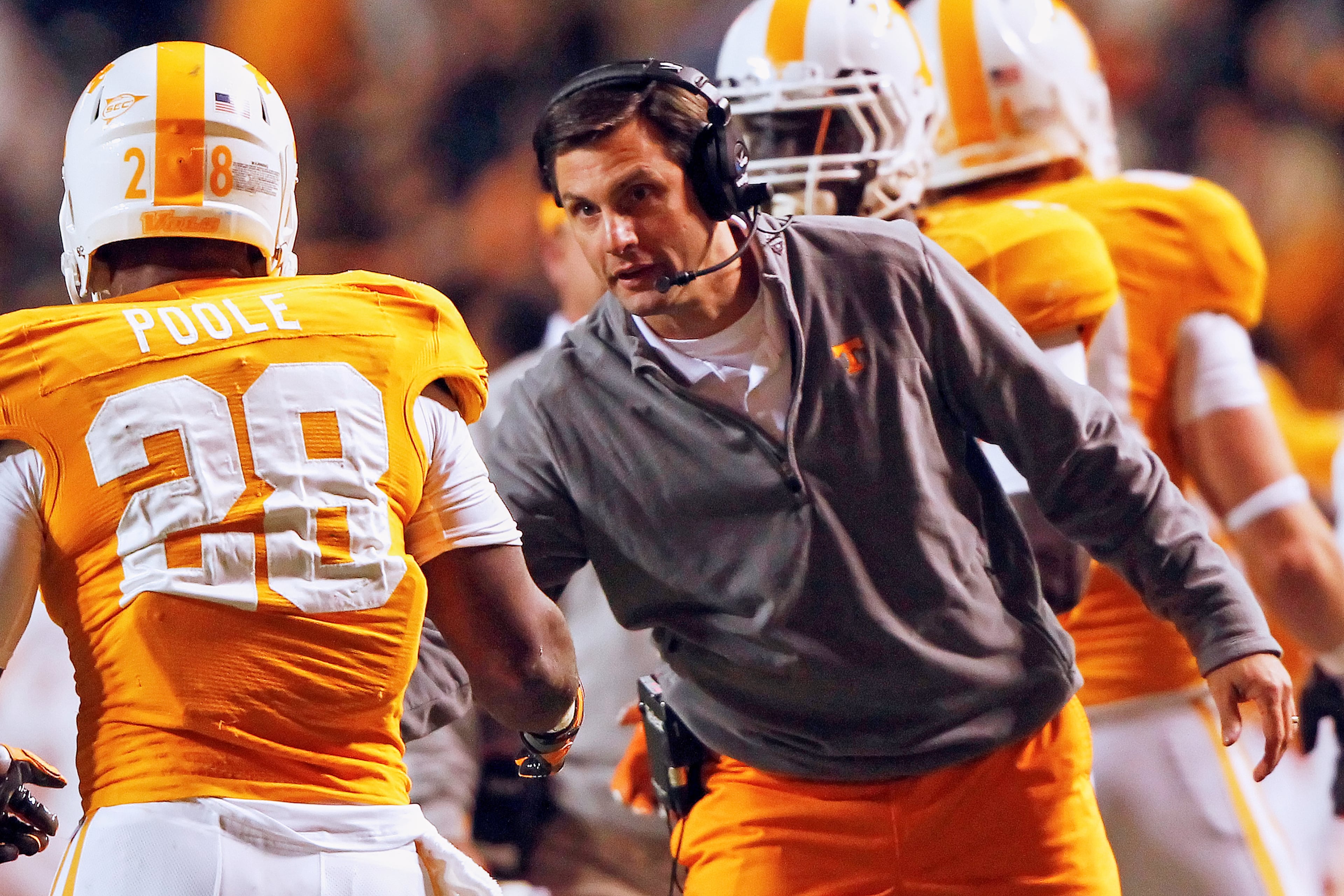 Tennessee head coach Derek Dooley, right, congratulates Tauren Poole (28) after he scored in the first quarter of an NCAA college football game against Middle Tennessee, Nov. 5, 2011, in Knoxville, Tenn. (Wade Payne/AP File)