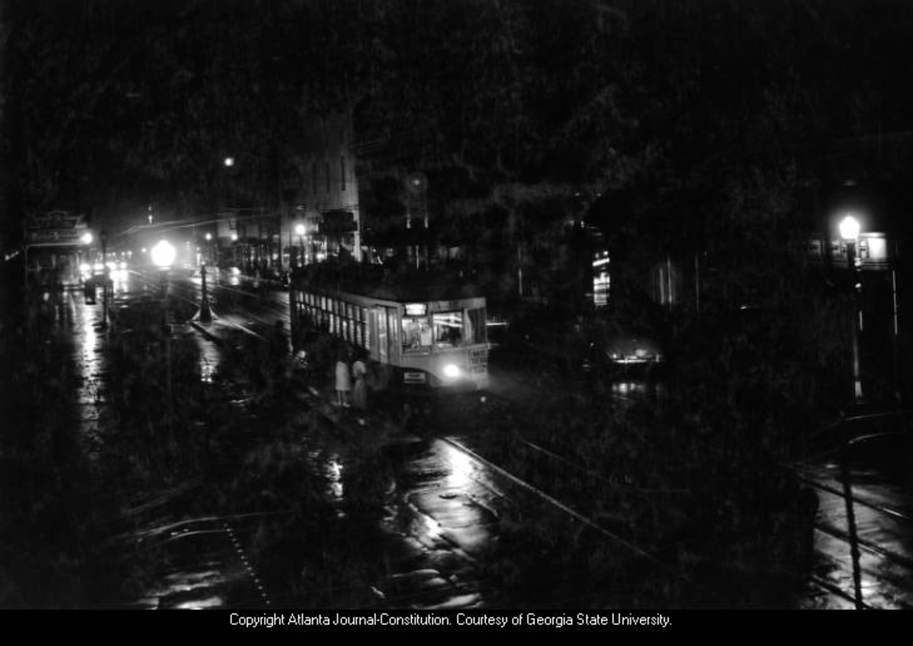 1941 -- A streetcar picks up passengers on a deserted night in downtown Atlanta. AJC FILE