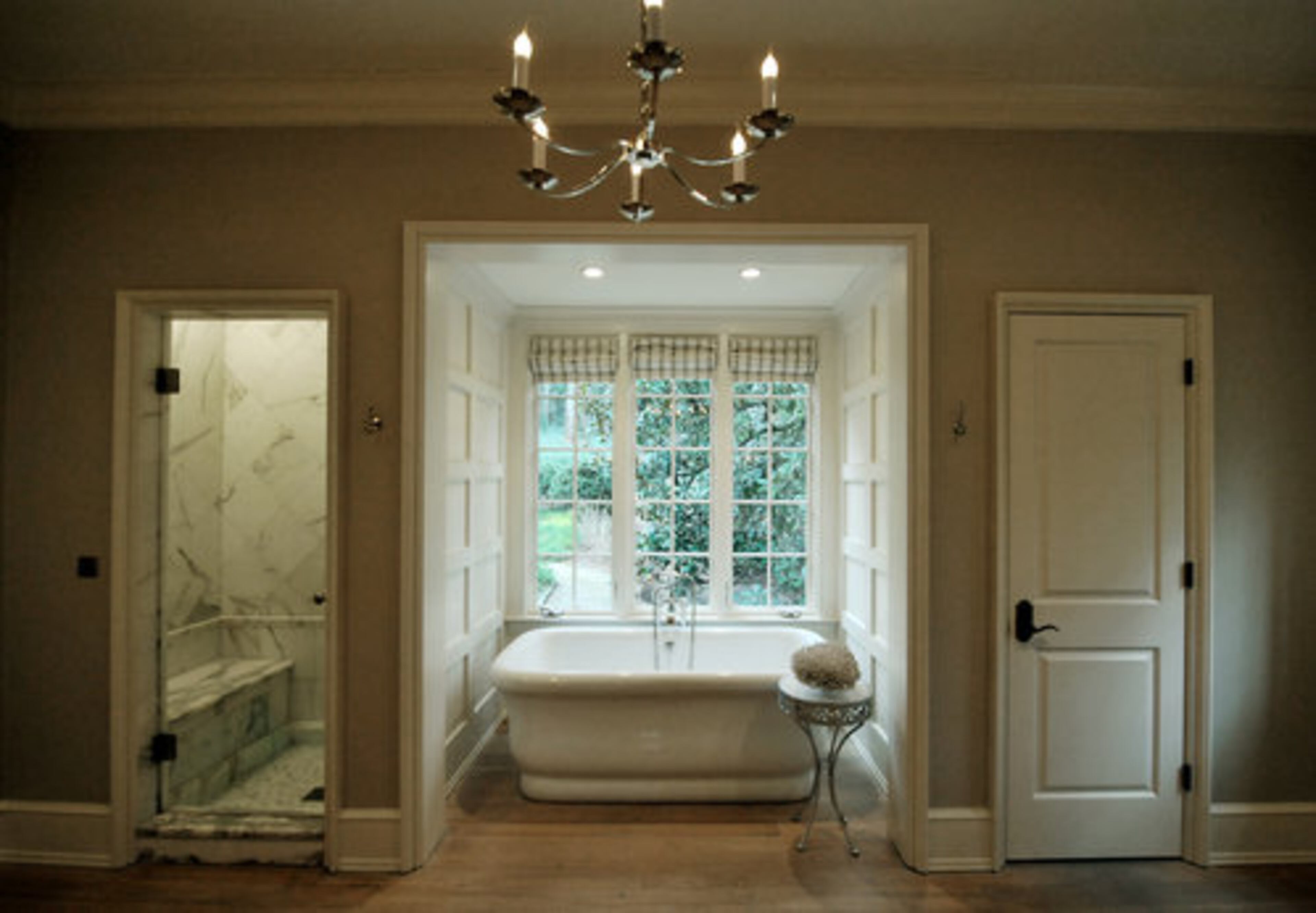 The home is set amid mature trees, providing a peaceful view from the master bath.