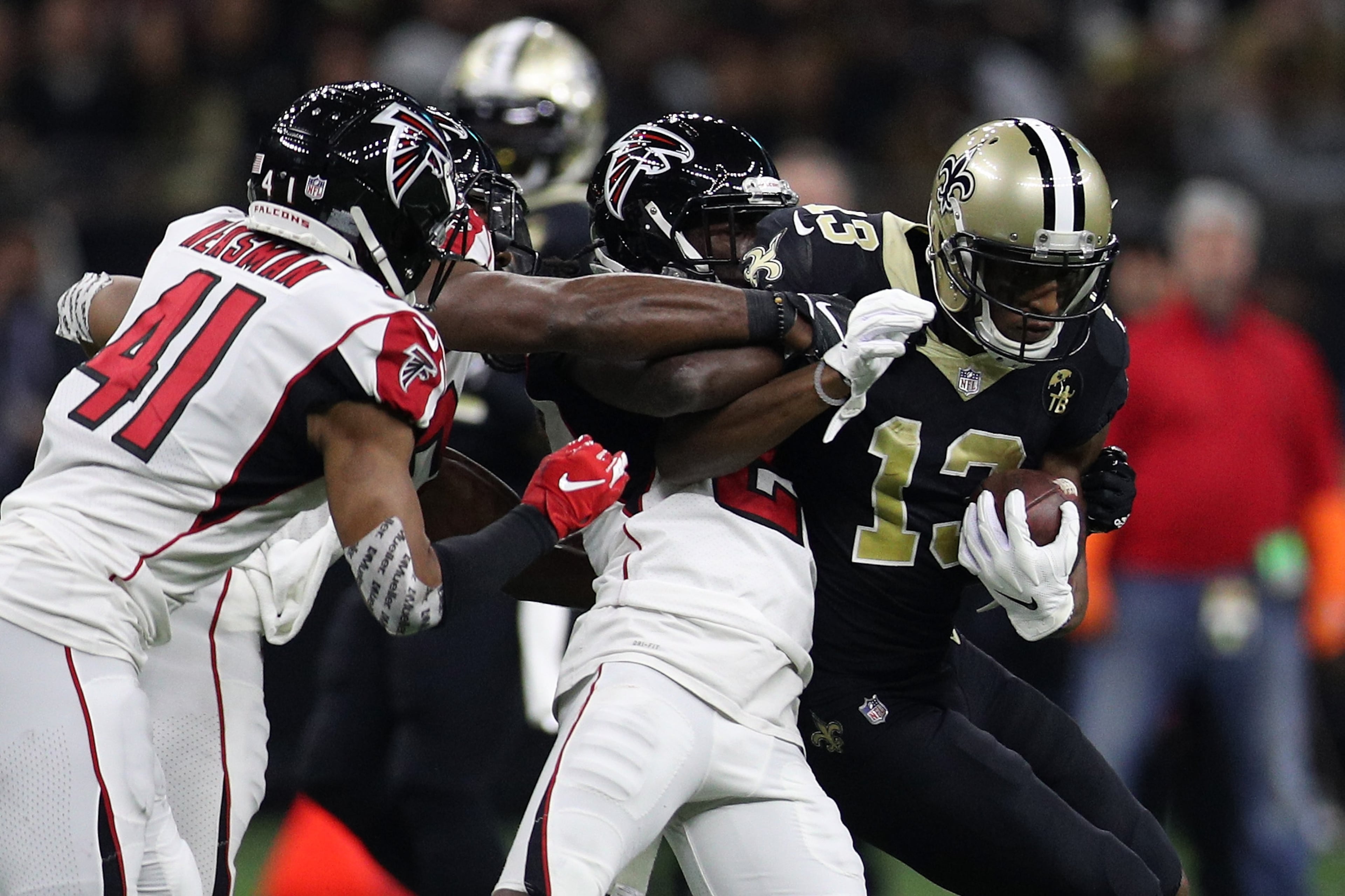 NEW ORLEANS, LA - NOVEMBER 22: Alvin Kamara #41 of the New Orleans Saints runs with the ball as Sharrod Neasman #41 of the Atlanta Falcons defends at the Mercedes-Benz Superdome on November 22, 2018 in New Orleans, Louisiana. (Photo by Chris Graythen/Getty Images)