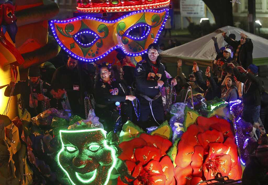 Harry Connick Jr. rides with members of the New Orleans Saints on Napoleon Avenue as the 1,400 men and women of the Krewe of Orpheus present a 38-float Mardi Gras parade entitled "The Orpheus Imaginarium" on the Uptown parade route in New Orleans on Monday, March 4, 2019. (Michael DeMocker/The Times-Picayune via AP)
