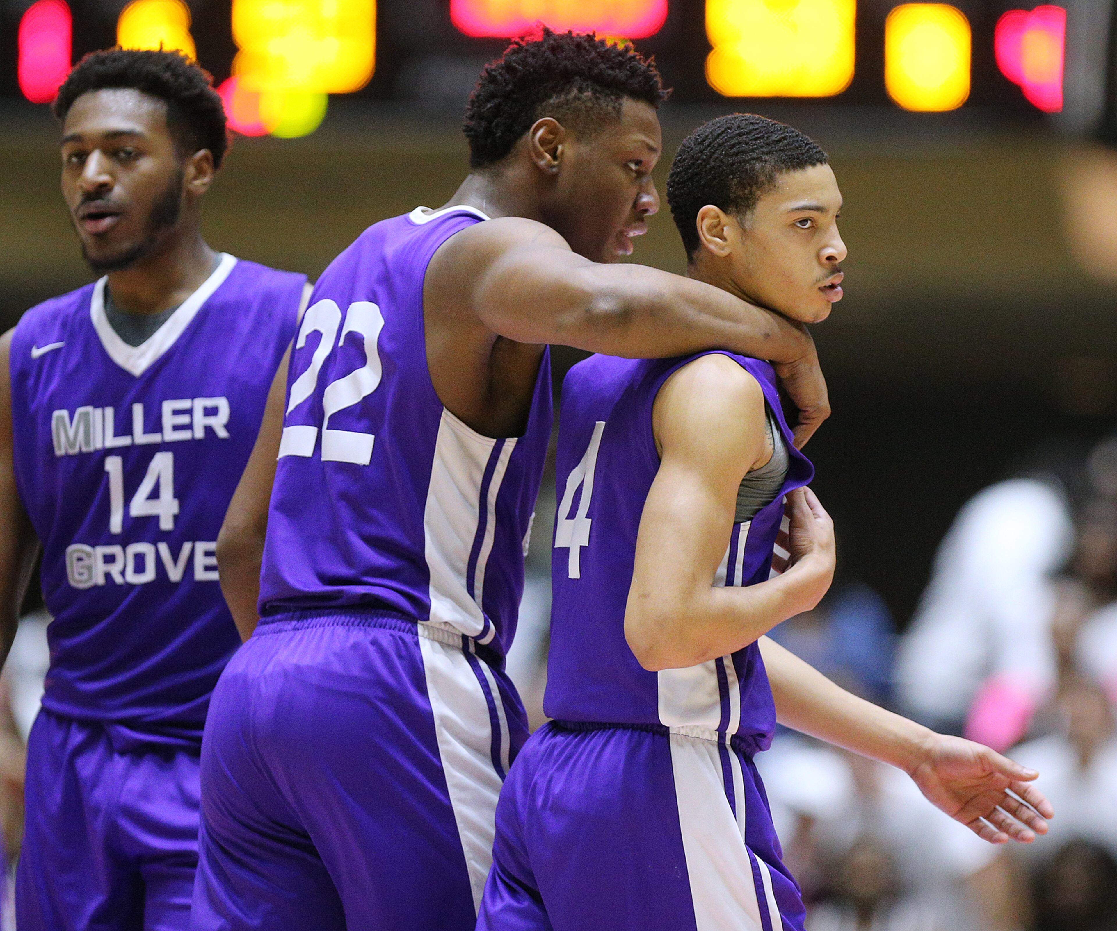 March 8, 2018 Macon: Miller Grove center Kevin Paige consoles guard Lorenzo Anderson after he made a foul against Warner Robins in the final minutes of their GHSA state basketball championship game on Thursday, March 8, 2018, in Macon. Curtis Compton/ccompton@ajc.com