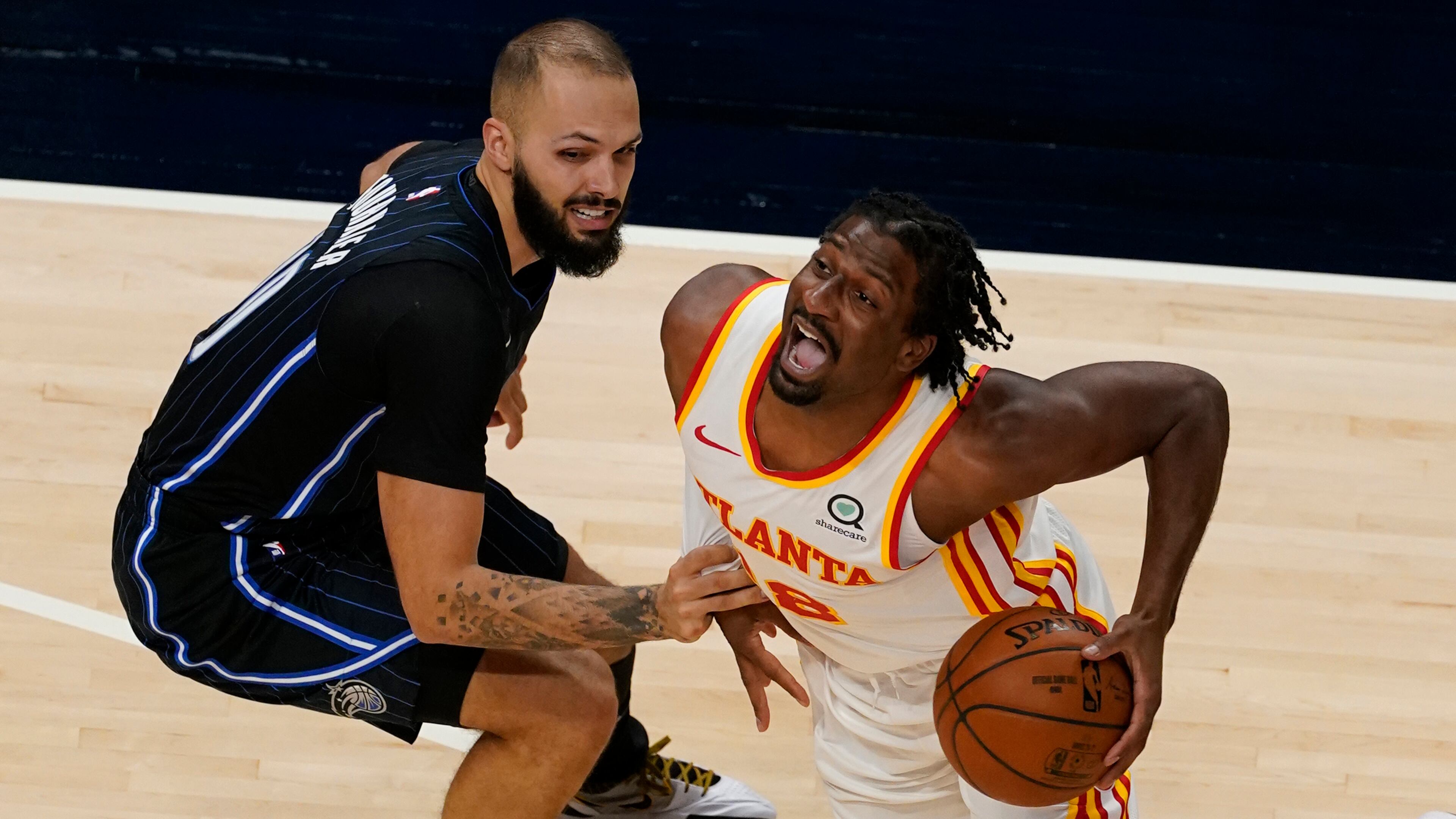 Atlanta Hawks forward Solomon Hill (right) drives against Orlando Magic guard Evan Fournier (left) during the first half Sunday, Dec. 13, 2020, in Atlanta. (John Bazemore/AP)