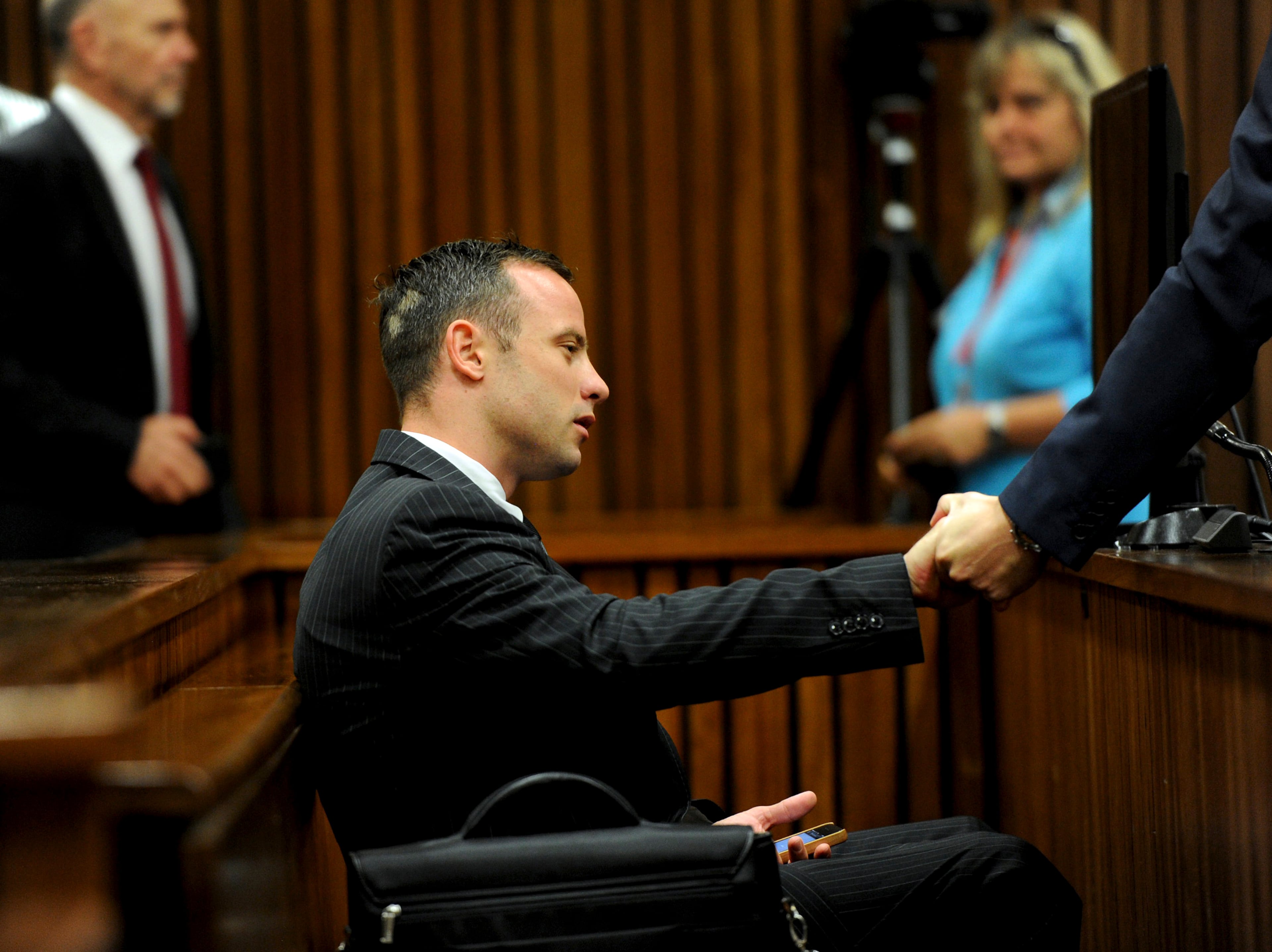 Oscar Pistorius sits in the dock as he waits for proceedings to begin at a court in Pretoria, South Africa, Tuesday, March 18, 2014. Pistorius is on trial for the murder of his girlfriend Reeva Steenkamp on Valentines Day, 2013. (AP Photo/Werner Beukes, Pool)
