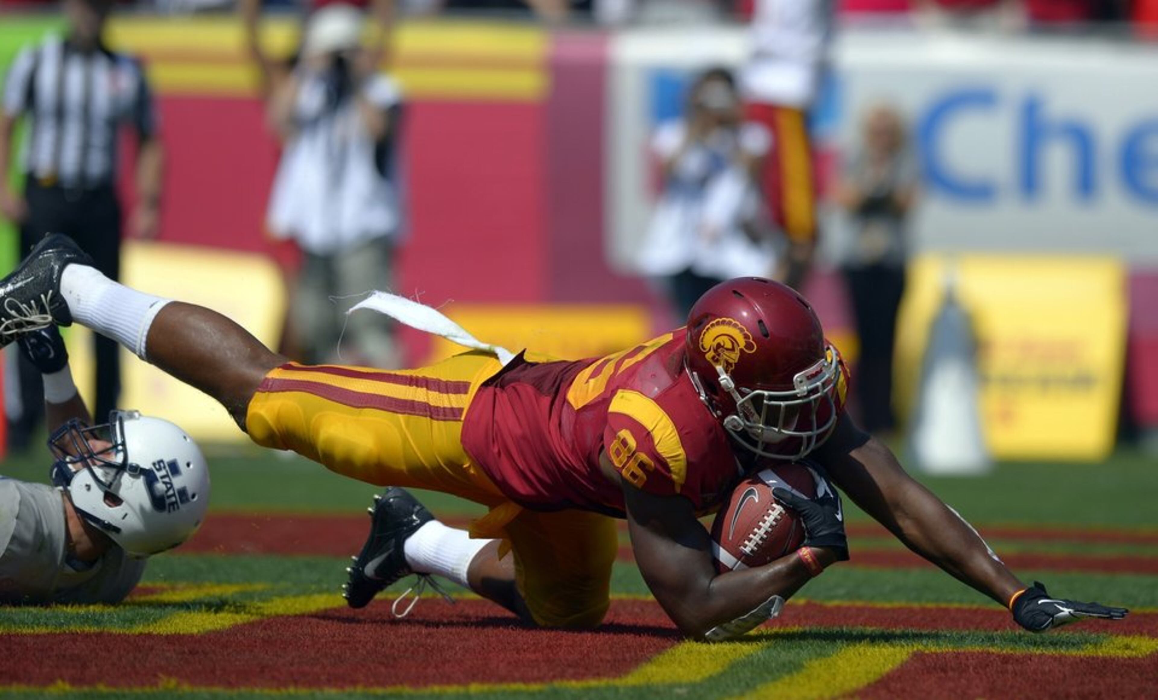 Southern California tight end Xavier Grimble, right, falls into the end zone for a touchdown as Utah State safety Brian Suite defends during the first half of an NCAA college football game on Saturday, Sept. 21, 2013, in Los Angeles. (AP Photo/Mark J. Terrill) ** Usable by LA and DC Only ** USC tight end Xavier Grimble lands in the end zone to score on a 30-yard pass play from Cody Kessler in the second quarter Saturday at the Coliseum. ( Mark J. Terrill / Associated Press / September 21, 2013 )