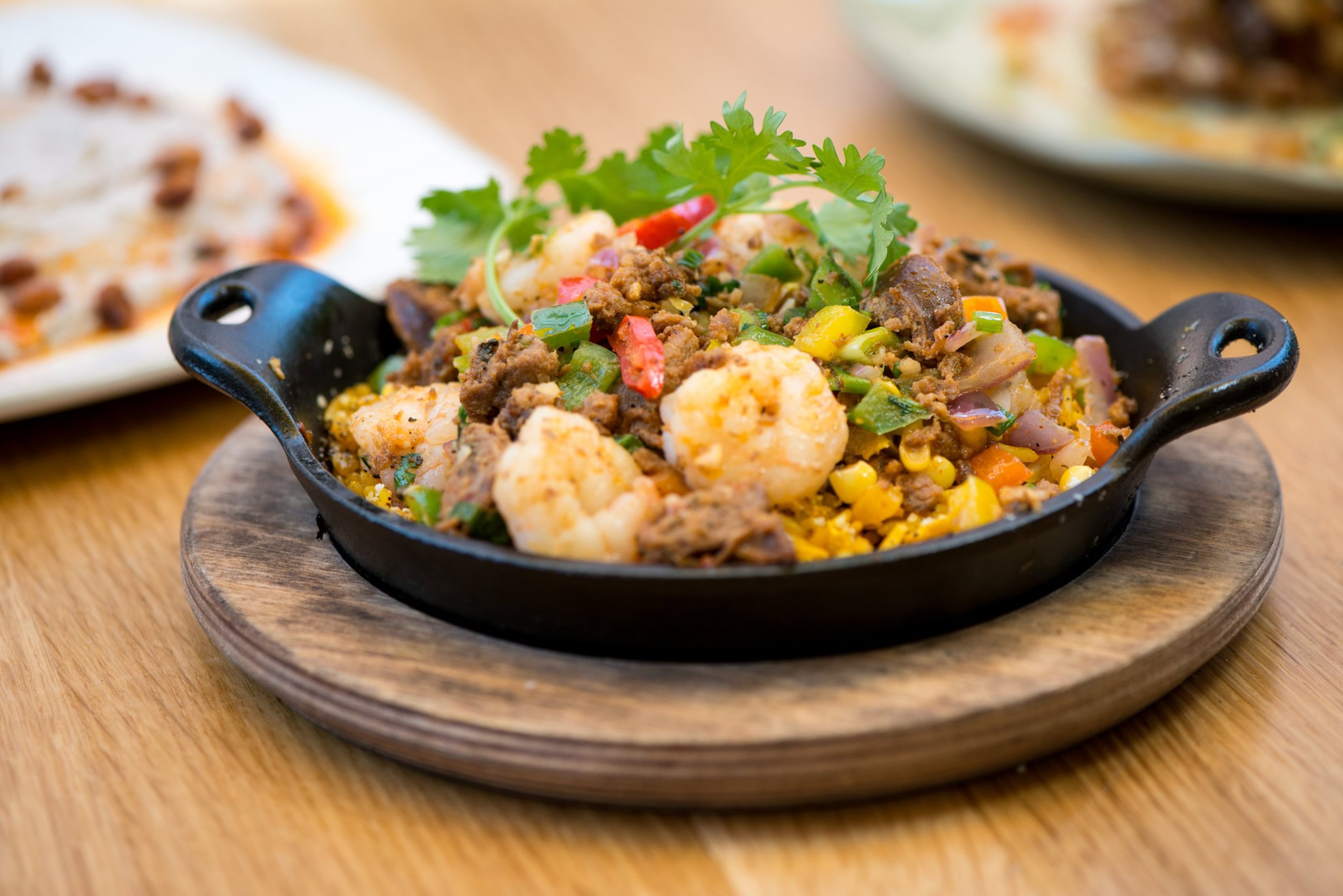 Shrimp and Chorizo Skillet with Gulf shrimp, chorizo, crispy rice, and tri-pepper hash. Photo credit- Mia Yakel.