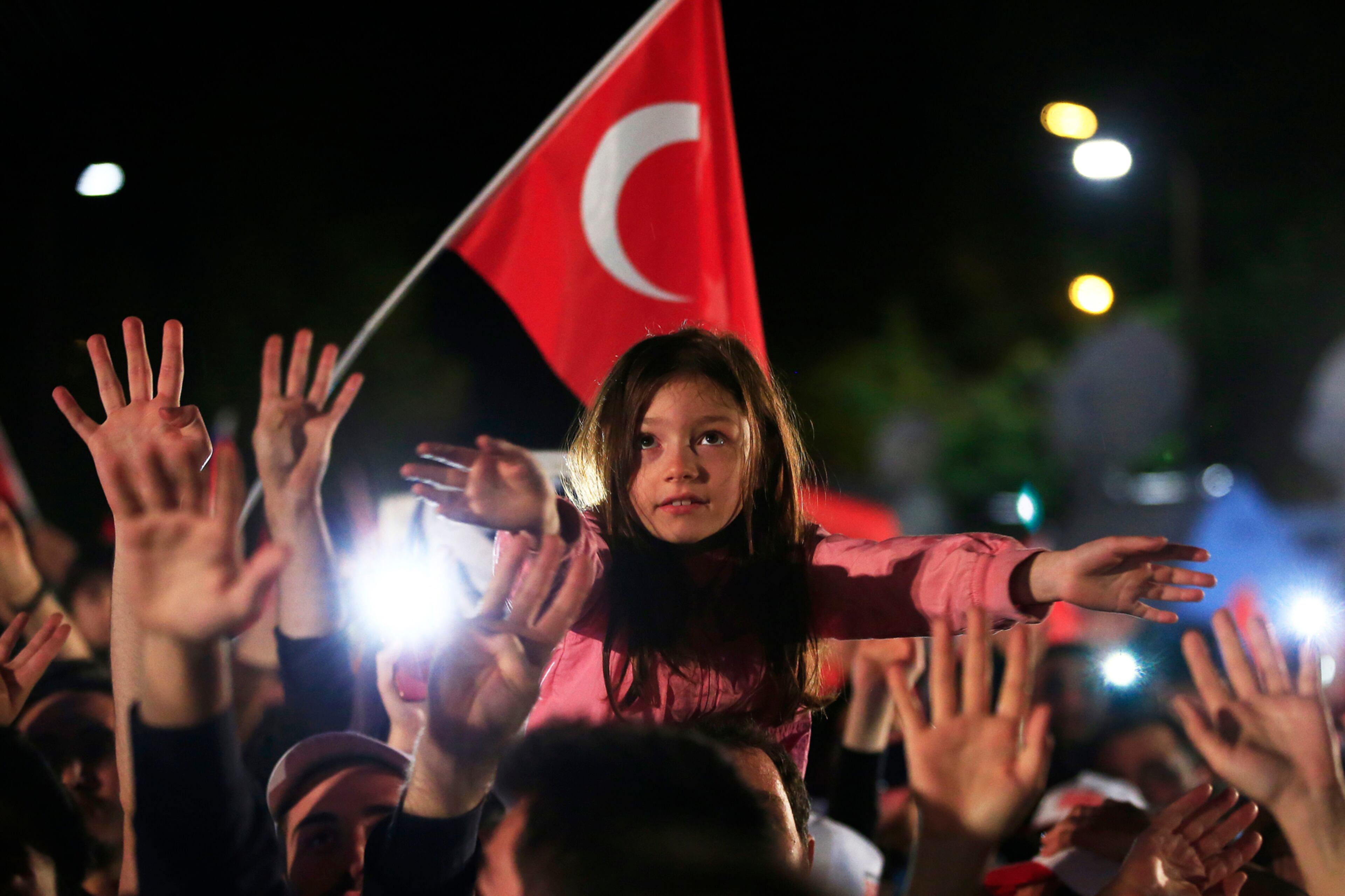 Supporters of Turkish President Recep Tayyip Erdogan celebrate in Istanbul, Turkey, on Sunday, April 16, 2017. Erdogan declared victory in Sunday's historic referendum that will grant sweeping powers to the presidency, hailing the result as a "historic decision." (AP Photo/Lefteris Pitarakis)
