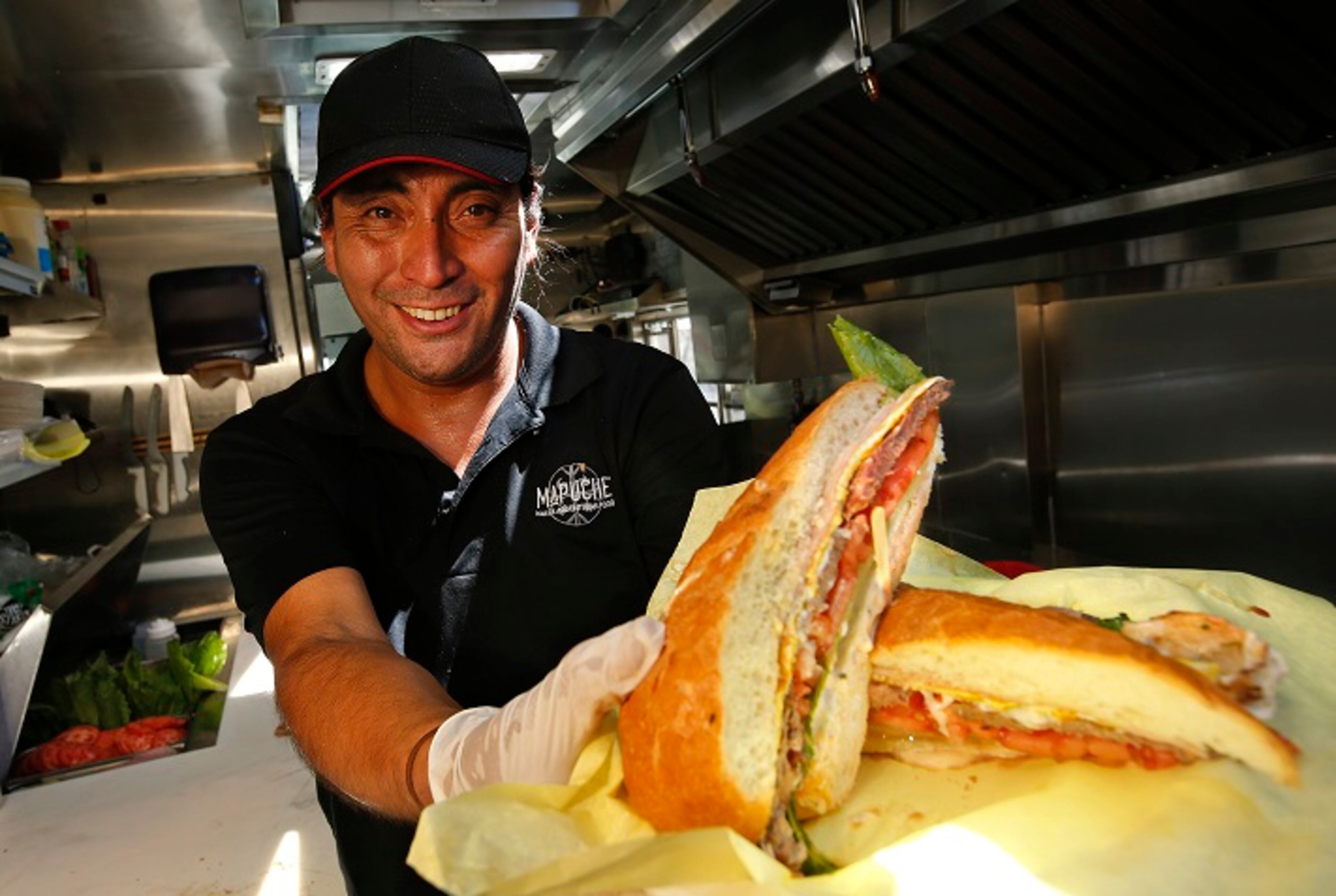 Carlos Leiva is photographed on July 26, 2017, with a Lomito (steak sandwich), one of the items on the menu of the Argentinian food truck, Mapuche, that he runs. (Mel Melcon/Los Angeles Times/TNS)