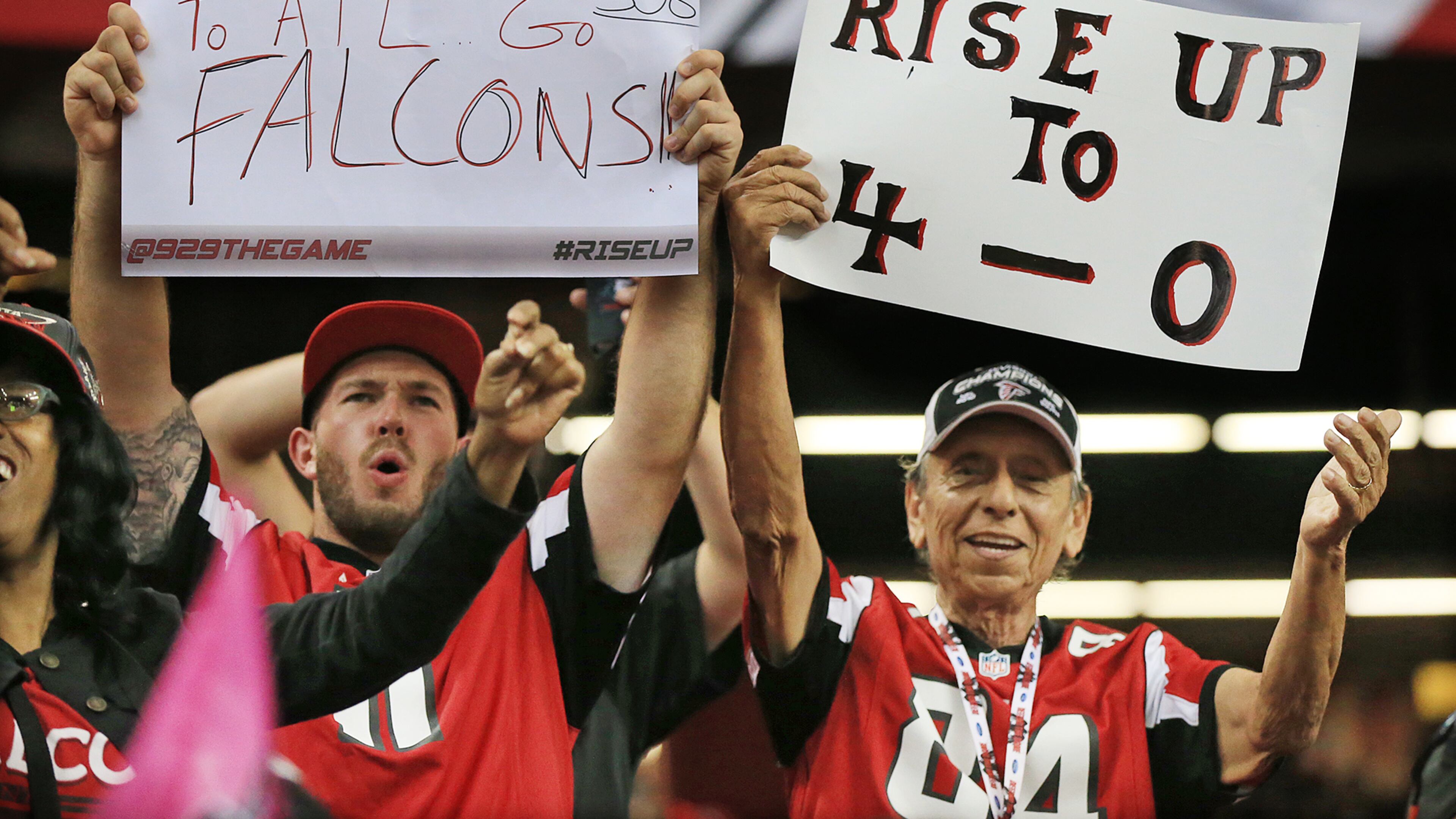 100415 ATLANTA: Falcons fans cheer as the team improves to 4-0 with a 48-21 victory over the Texans in a football game on Sunday, Oct. 4, 2015, in Atlanta.