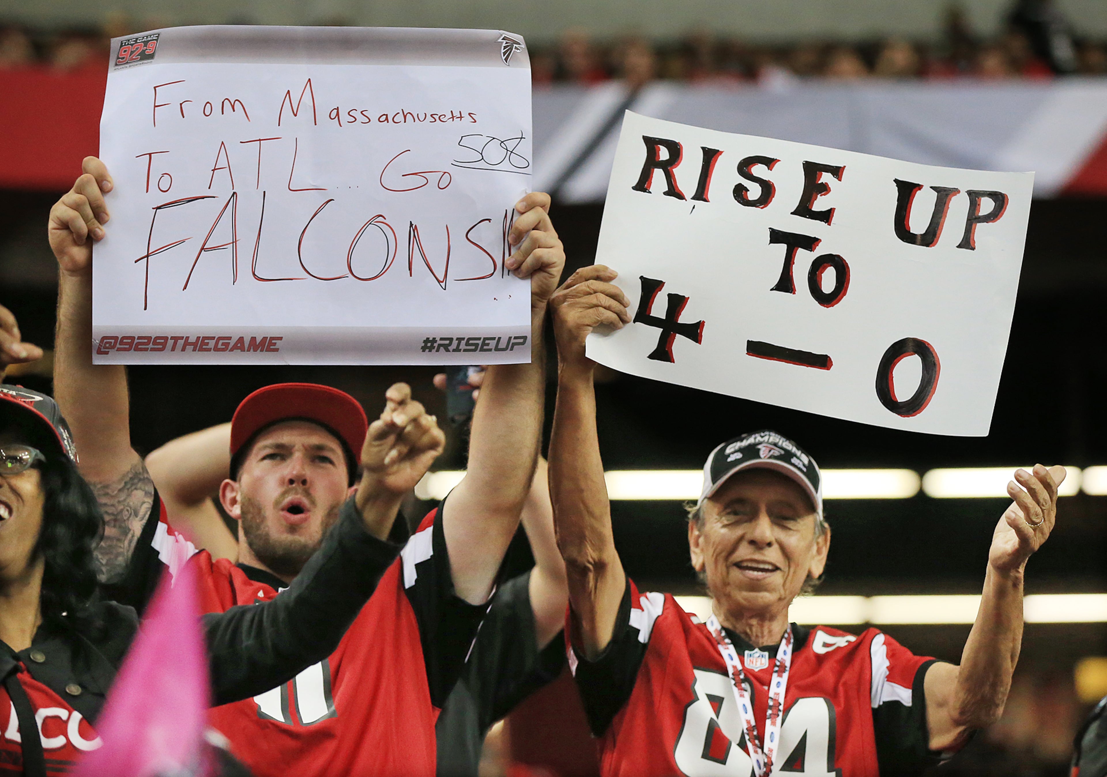 100415 ATLANTA: Falcons fans cheer as the team improves to 4-0 with a 48-21 victory over the Texans in a football game on Sunday, Oct. 4, 2015, in Atlanta.