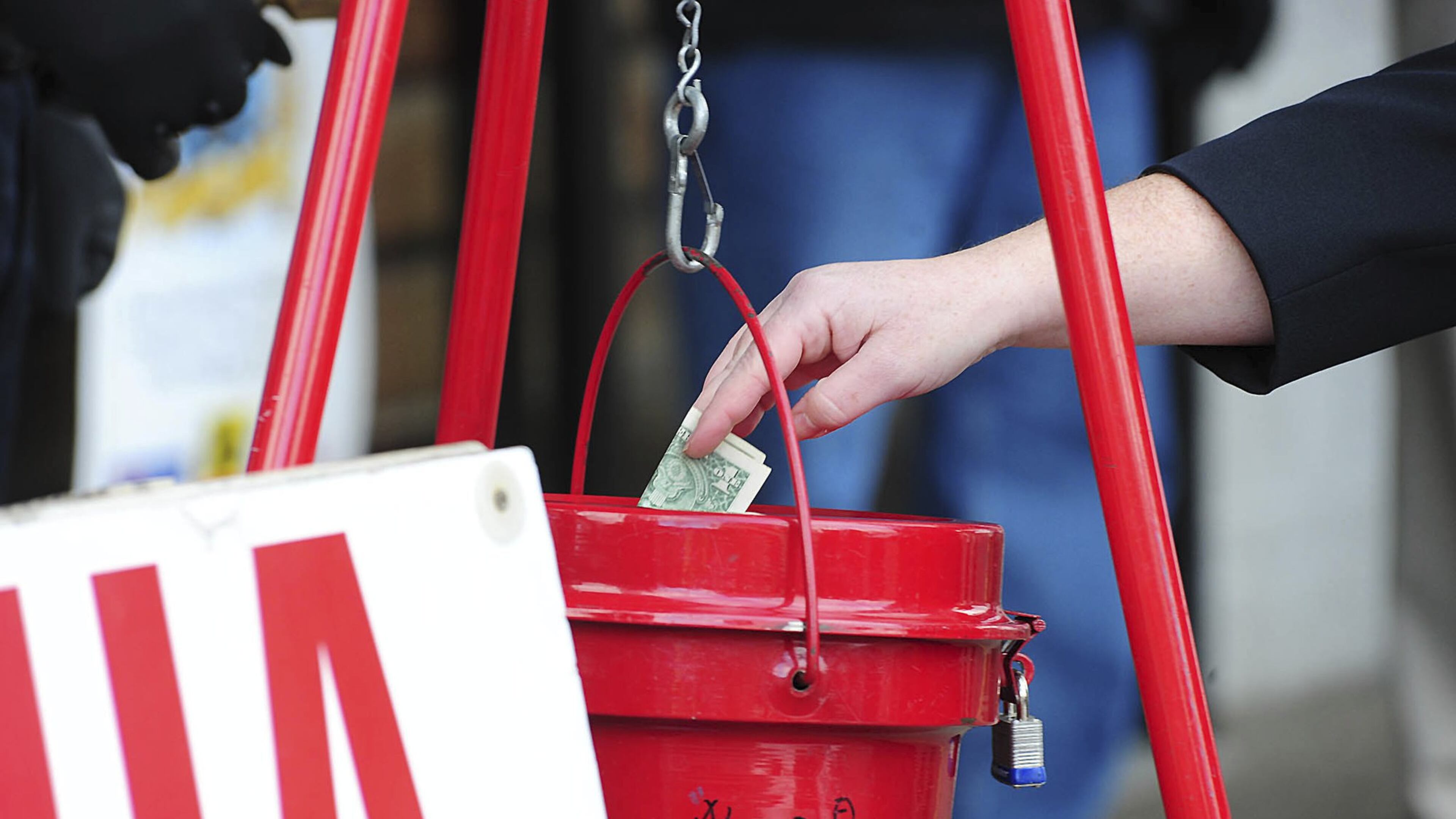 A patron donates money in a Salvation Army red kettle in Wilkes-Barre, Pa. In the recent season of giving, charity seemed to be getting an extra jolt because the popular tax deduction for charitable donations will lose a lot of its punch. MARK MORAN / THE CITIZENS’ VOICE VIA AP
