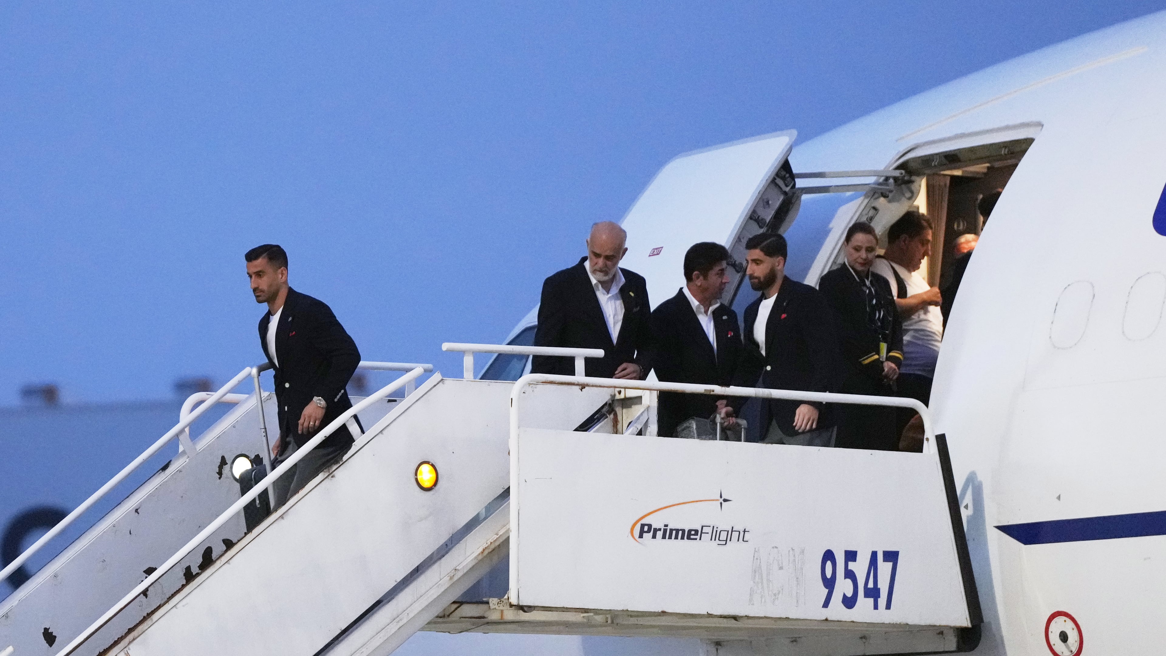 Iran's Ehsan Hajisafi, left, arrives with his teammates for the World Cup soccer tournament in Tijuana, Mexico, Sunday, June 7, 2026. (AP Photo/Gregory Bull)