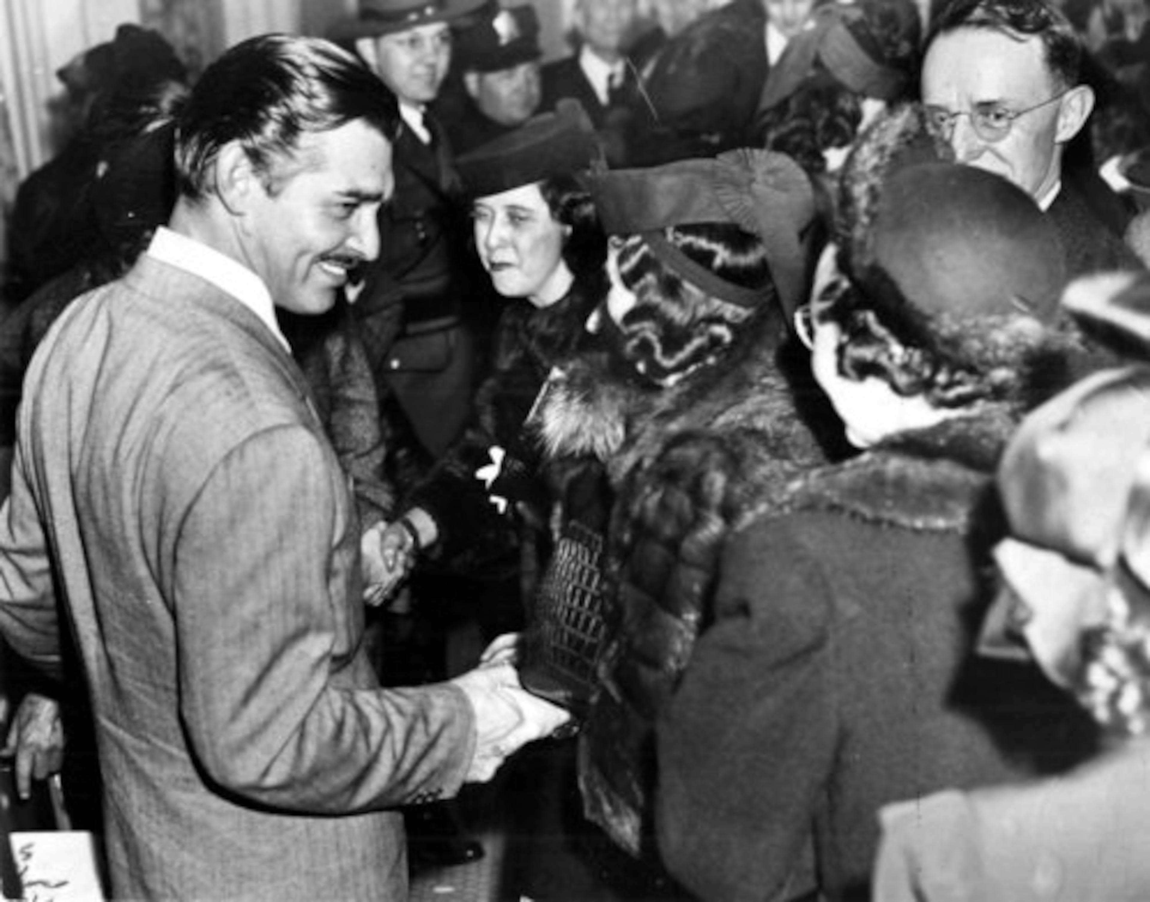 Gable greets some of his female admirers.
