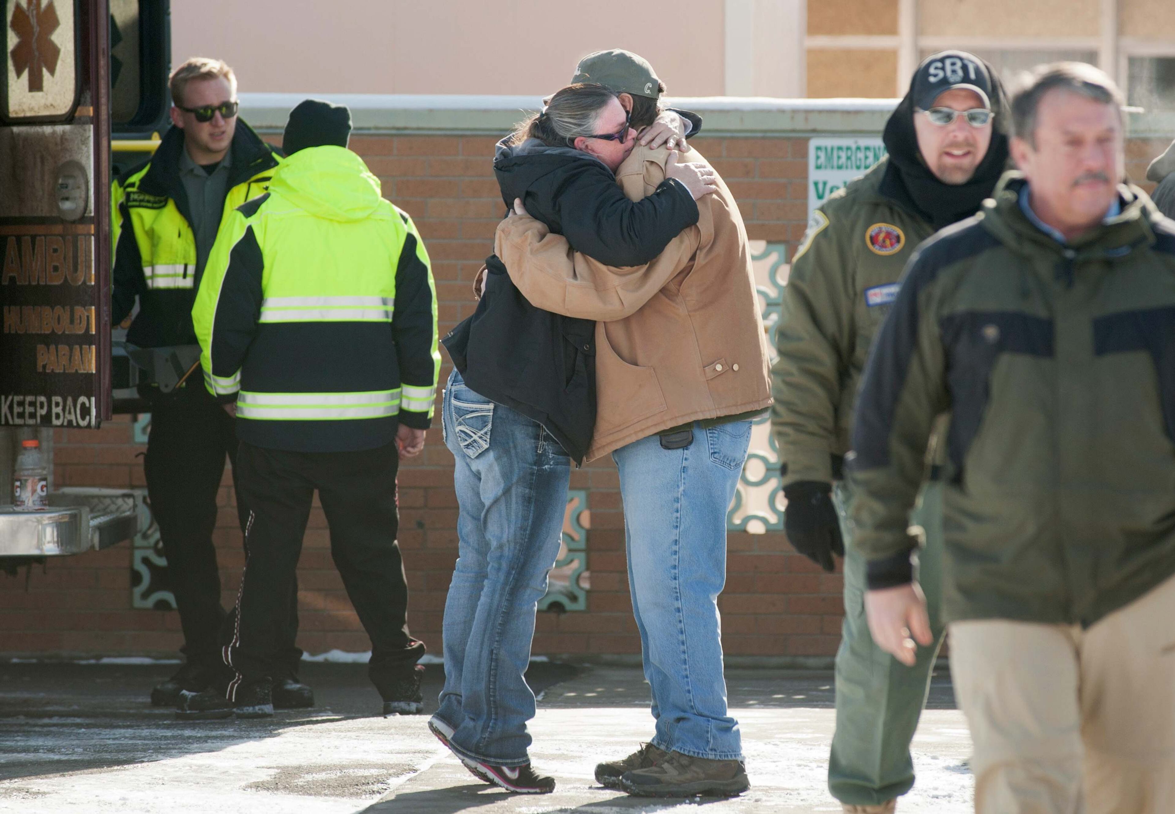 A woman hugs Chris Montes after hearing that Montes was one of the rescuers that found a family in a remote mountain range northeast of Reno, in Lovelock, Nevada, December 10, 2013. A Nevada couple and four young children reported missing on Sunday were found safe by rescue workers on Tuesday huddled in a canyon, a dispatch supervisor for the Pershing County Sheriff's Office said. Montes said the group was stranded after their truck rolled over but that they were doing well and were in good spirits when he found them. REUTERS/James Glover