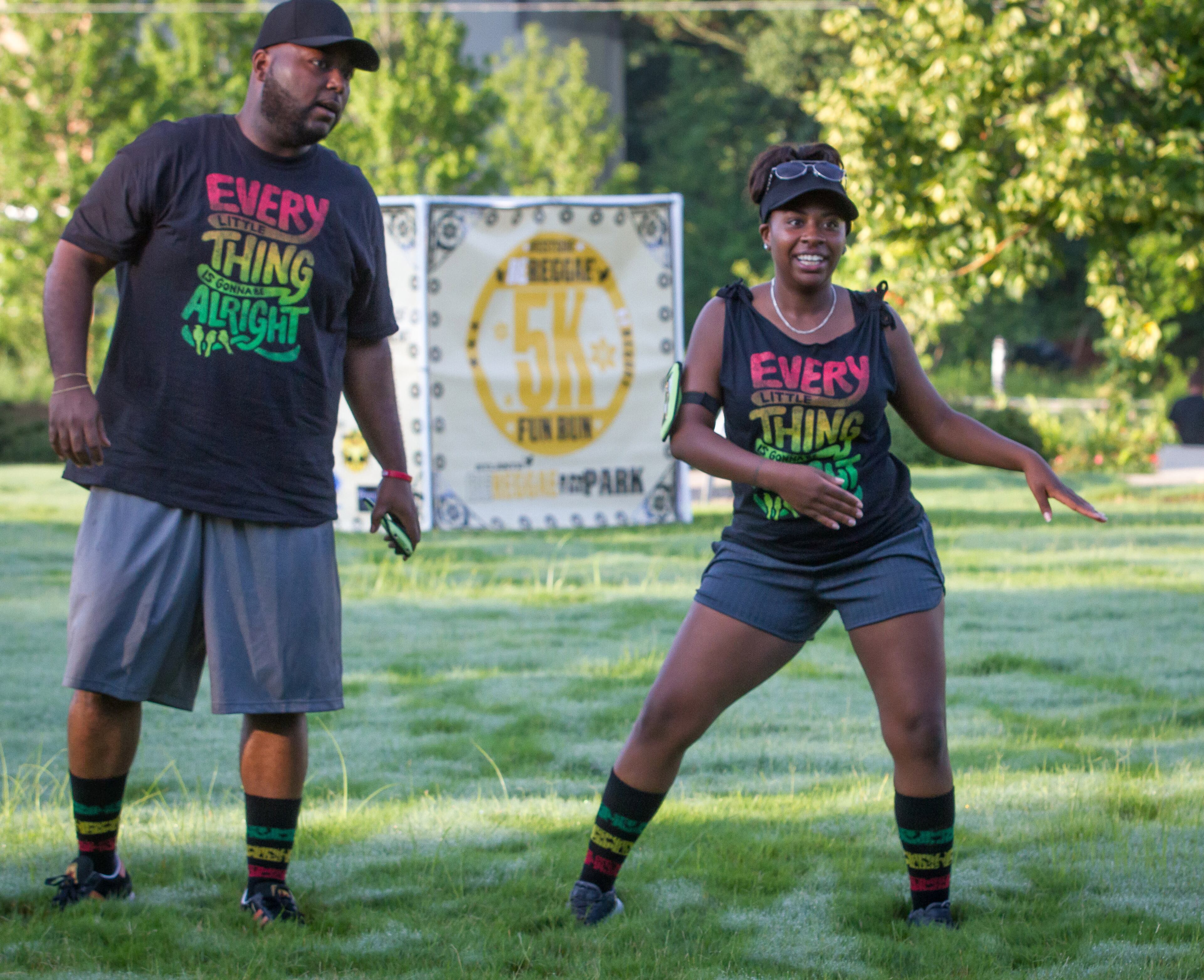 Ayshar Willson (L) and Nneka Myricks do warm up exercises before the start of the Reggae 5K Fun Run near Gordon-White Park in the West End Neighborhood Saturday, July 7, 2018. STEVE SCHAEFER / SPECIAL TO THE AJC