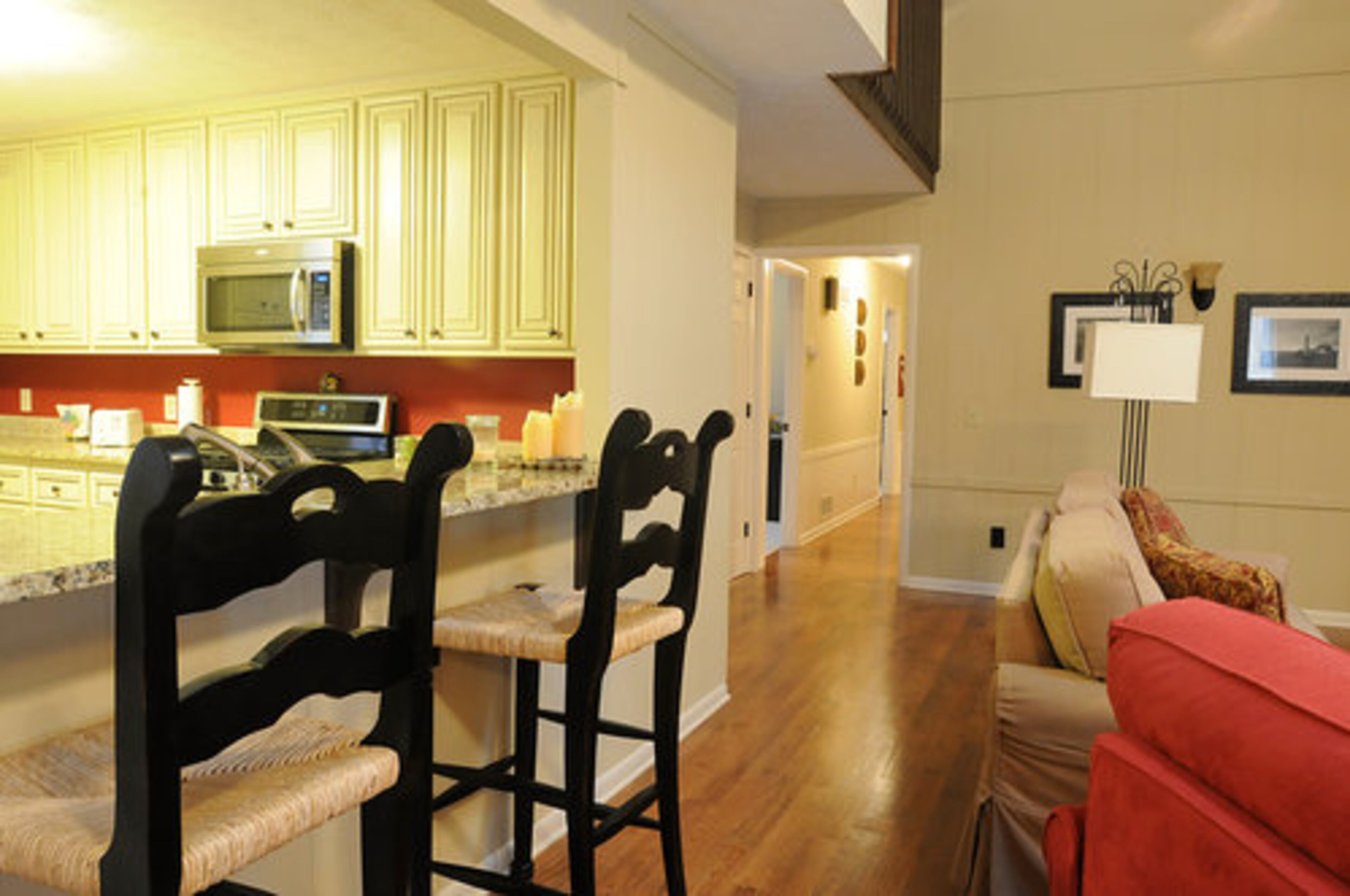 The kitchen was completely renovated. A center Island was completely replaced, and cabinets were refaced, added new granite counter tops, removed a 30 year old trash compactor and replaced it with a cabinet trash can pull out. " We chose glazed cream cabinets with dark accents cabinets to make the room bright without being white."