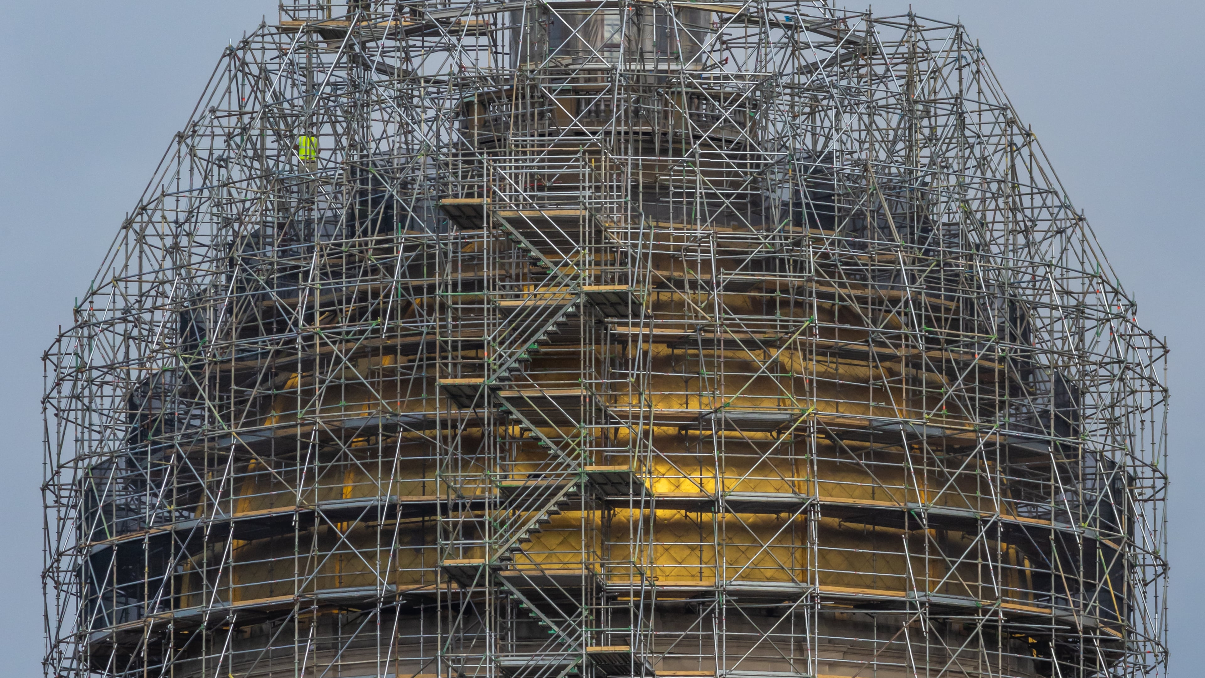 Workers are replacing the iconic gold leaf atop the dome of the Georgia Capitol as part of $392 million worth of renovations that include a new legislative office building, parking deck, meeting rooms, offices and air conditioning system. A series of budget surpluses have left Georgia flush with cash to pay for such projects. (John Spink/AJC 2024)