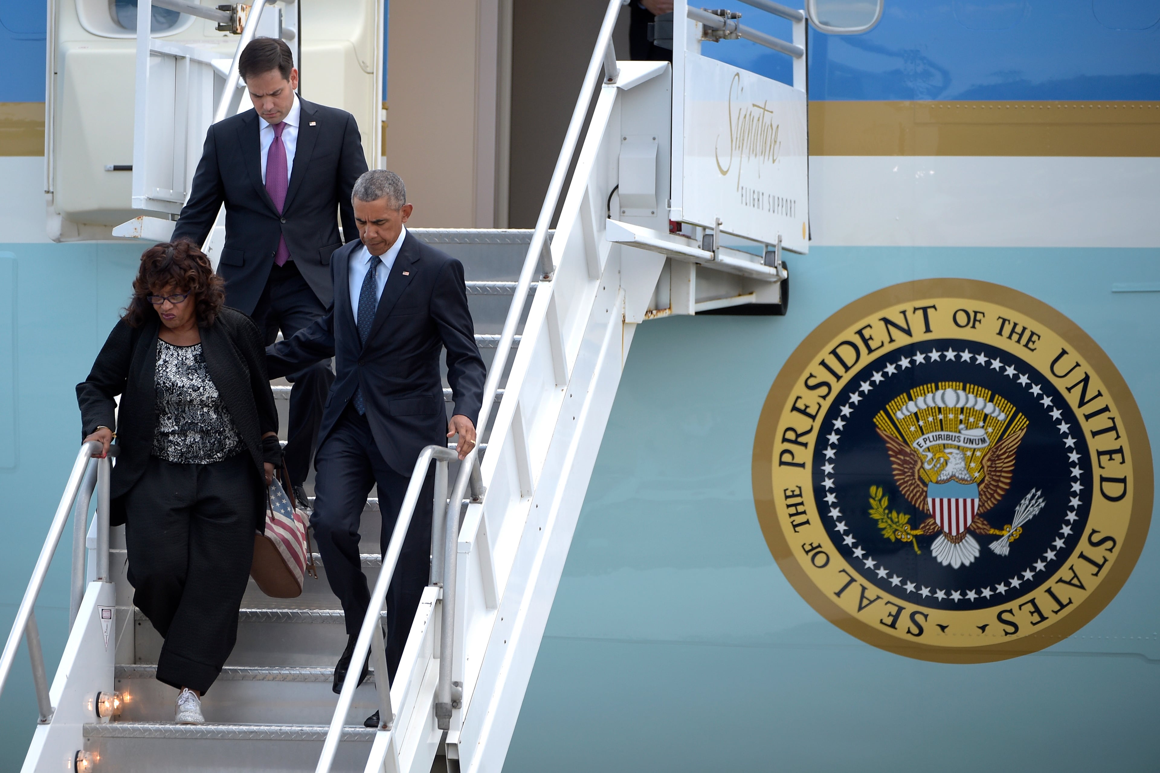 Pres. Barack Obama, accompanied by Rep. Corrine Brown, D-Fla. and Sen. Marco Rubio, R-Fla., walk down the stairs from Air Force One at Orlando International Airport in Orlando, Fla., Thursday, June 16, 2016. Obama is in Orlando today to pay respects to the victims of the Pulse nightclub shooting and meet with families of victims of the attack. (AP Photo/Phelan M. Ebenhack)