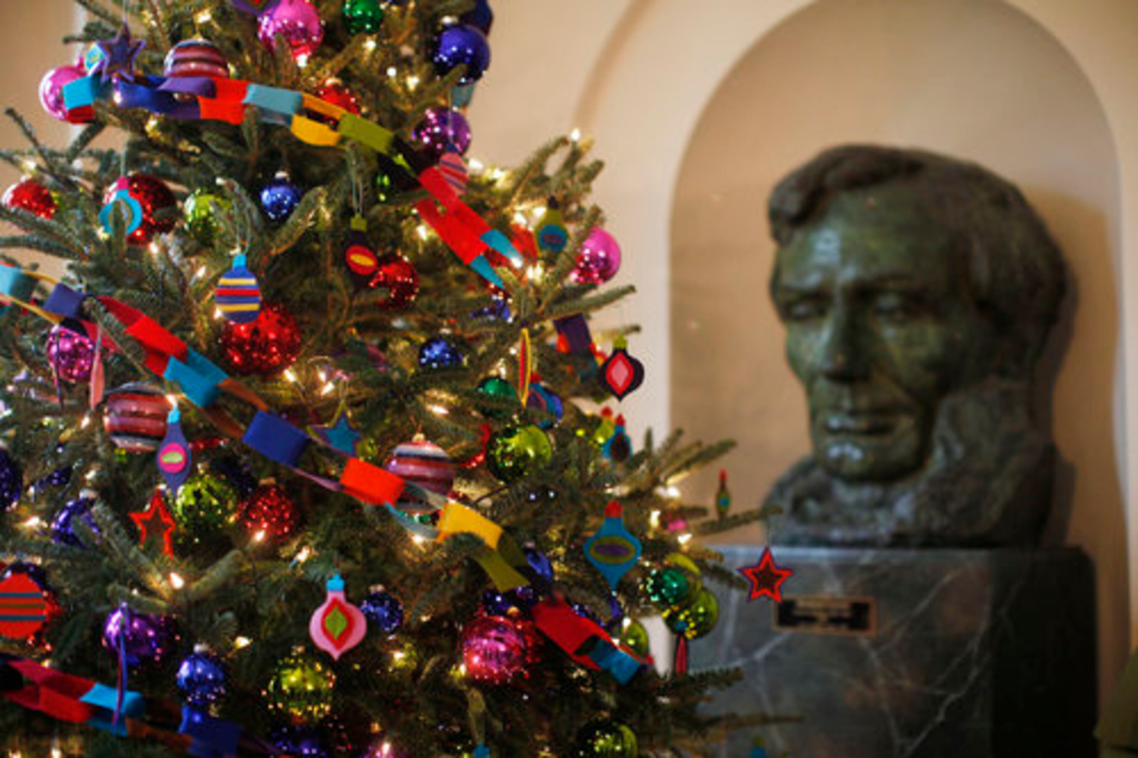 Felt garlands adorn a Christmas tree as a bust of Abraham Lincoln is seen at rear in the East Garden Room.