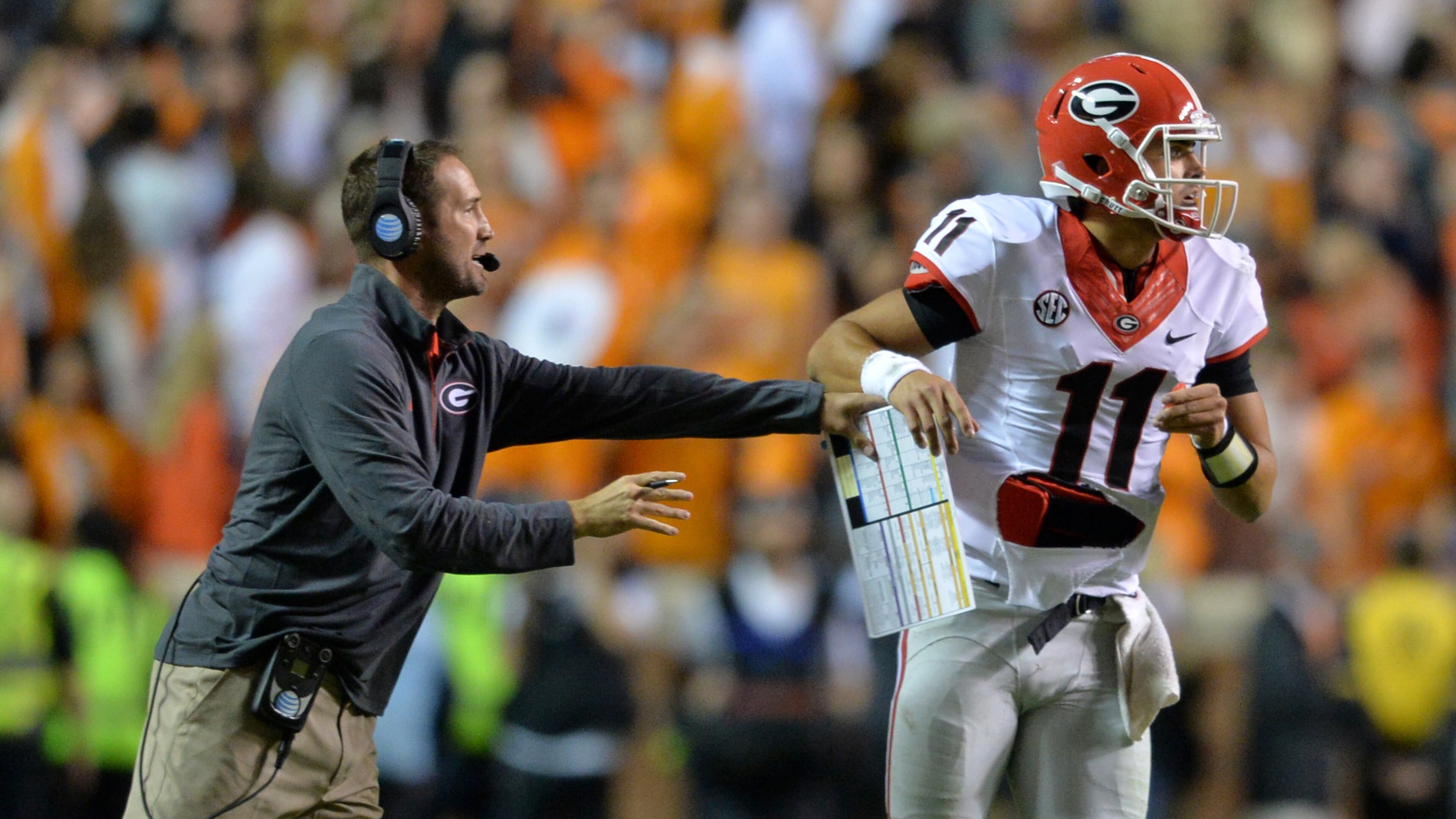Georgia offensive coordinator Brian Schottenheimer sends in a play with quarterback Greyson Lambert late in the 4th quarter against Tennessee in Knoxville. (Brant Sanderlin / bsanderlin@ajc.com)