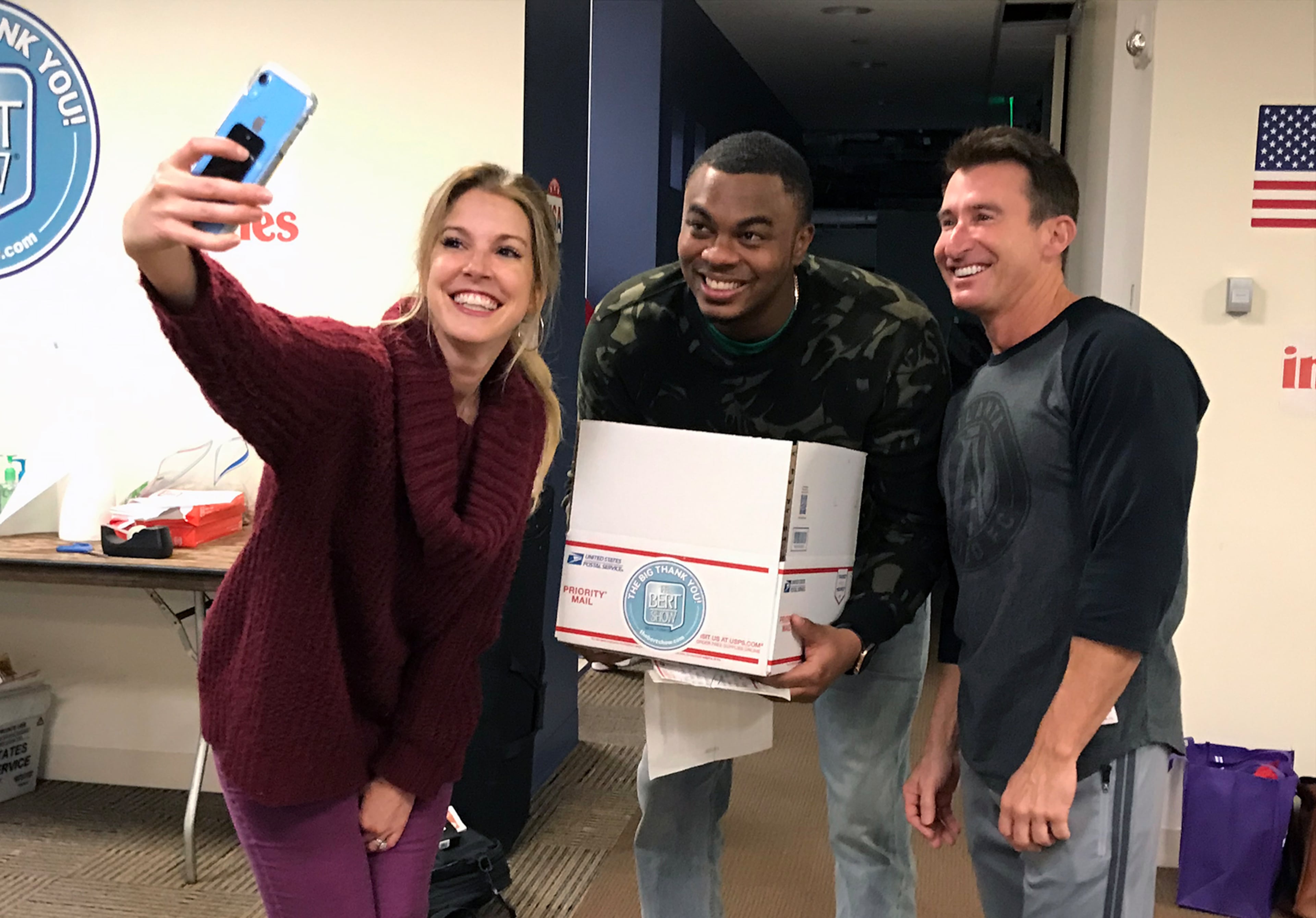 The Bert Show's Kristin Klingshirn, Moe Mitchell and Bert Weiss in November of 2019 during a charity event where the Bert Show collected letters for all American military overseas during Thanksgiving. RODNEY HO/AJC