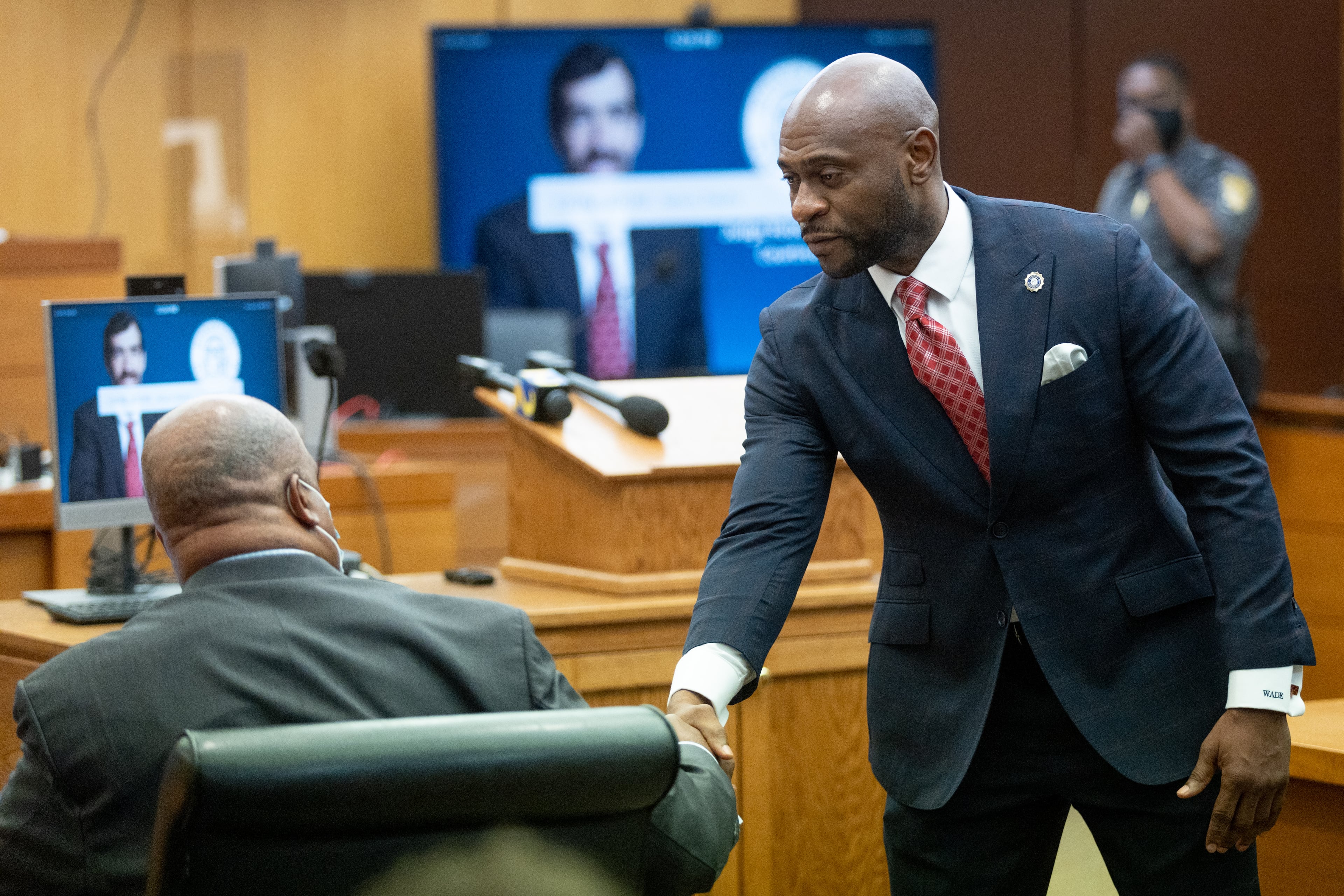 Rudy Giuliani's attorney Bill Thomas (L) and lawyer Nathan Wade for the DA shake hands before the start of a court challenge to Giuliani's subpoena to the Fulton County special grand jury examining Georgia's 2020 elections at Fulton Superior Court Thursday, August 9, 2022. Steve Schaefer / steve.schaefer@ajc.com)