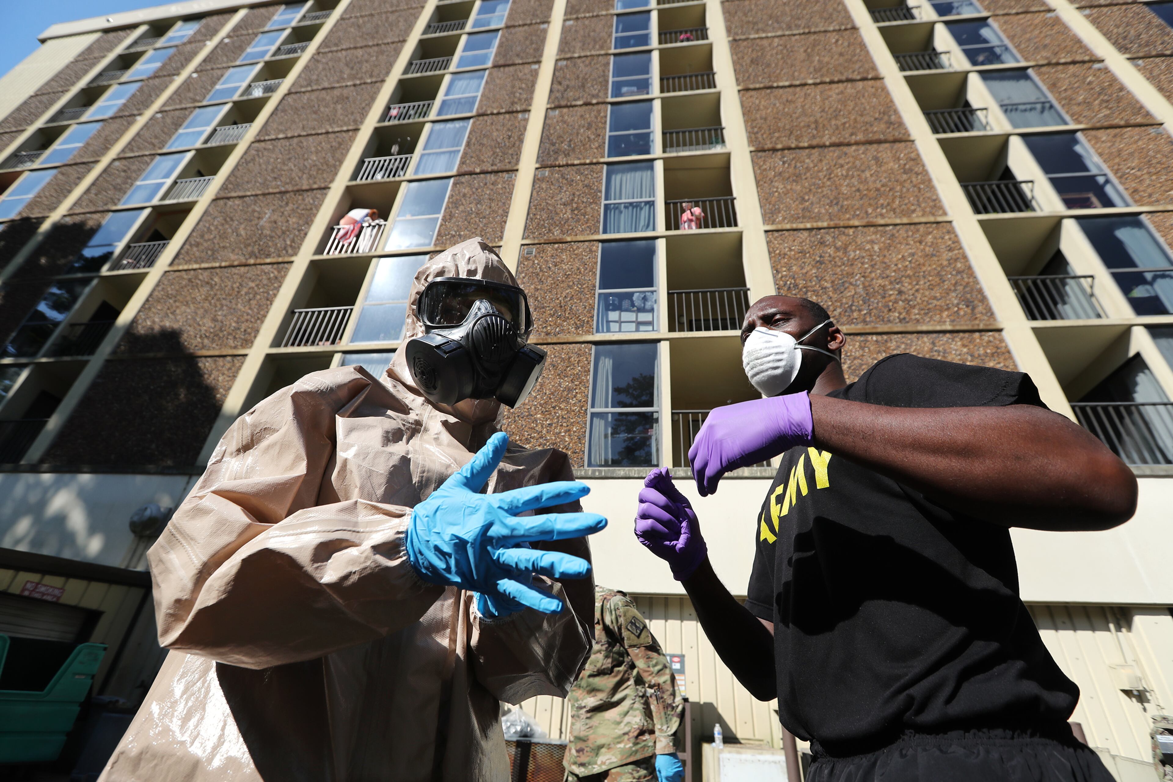 *** DO NOT RUN ONLINE OR PUBLISH UNTIL STORY RUNS *** April 21, 2020 Sandy Springs: Spc. Marquez Thomas (right) helps Spc. Tyesha Carpenter (left) gear up to enter Campbell-Stone retirement community with the Georgia Army National Guard 265th Chemical Battalion to disinfect the facility on Tuesday, April 21, 2020, in Sandy Springs. Curtis Compton ccompton@ajc.com
